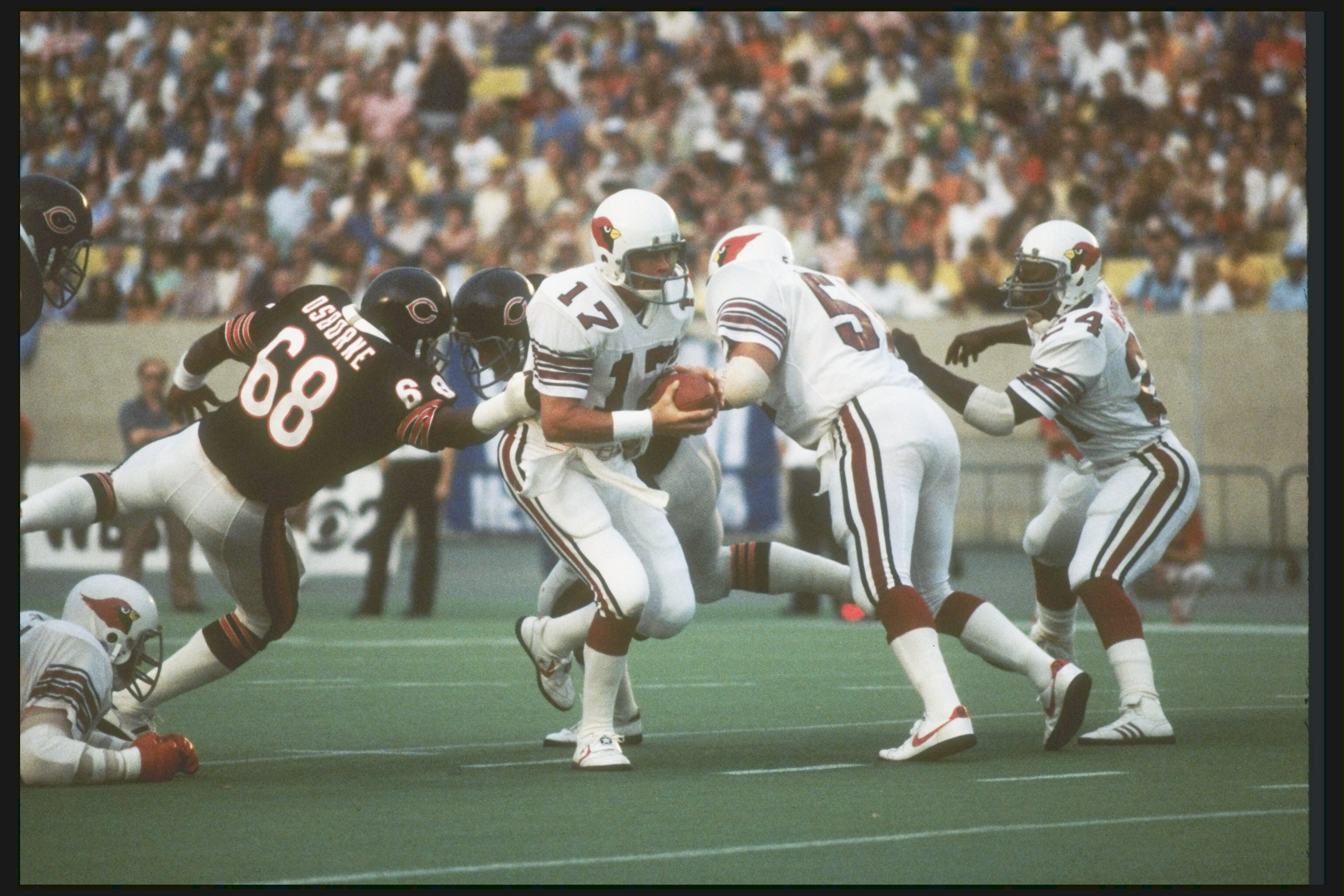30 Aug 1980:  St Louis Cardinals quarterback Jim Hart avoids the grasp of a Chicago Bears defensive lineman during a preseason game at Soldier Field in Chicago, Illinois.  Mandatory Credit: Jonathan Daniel  /Allsport