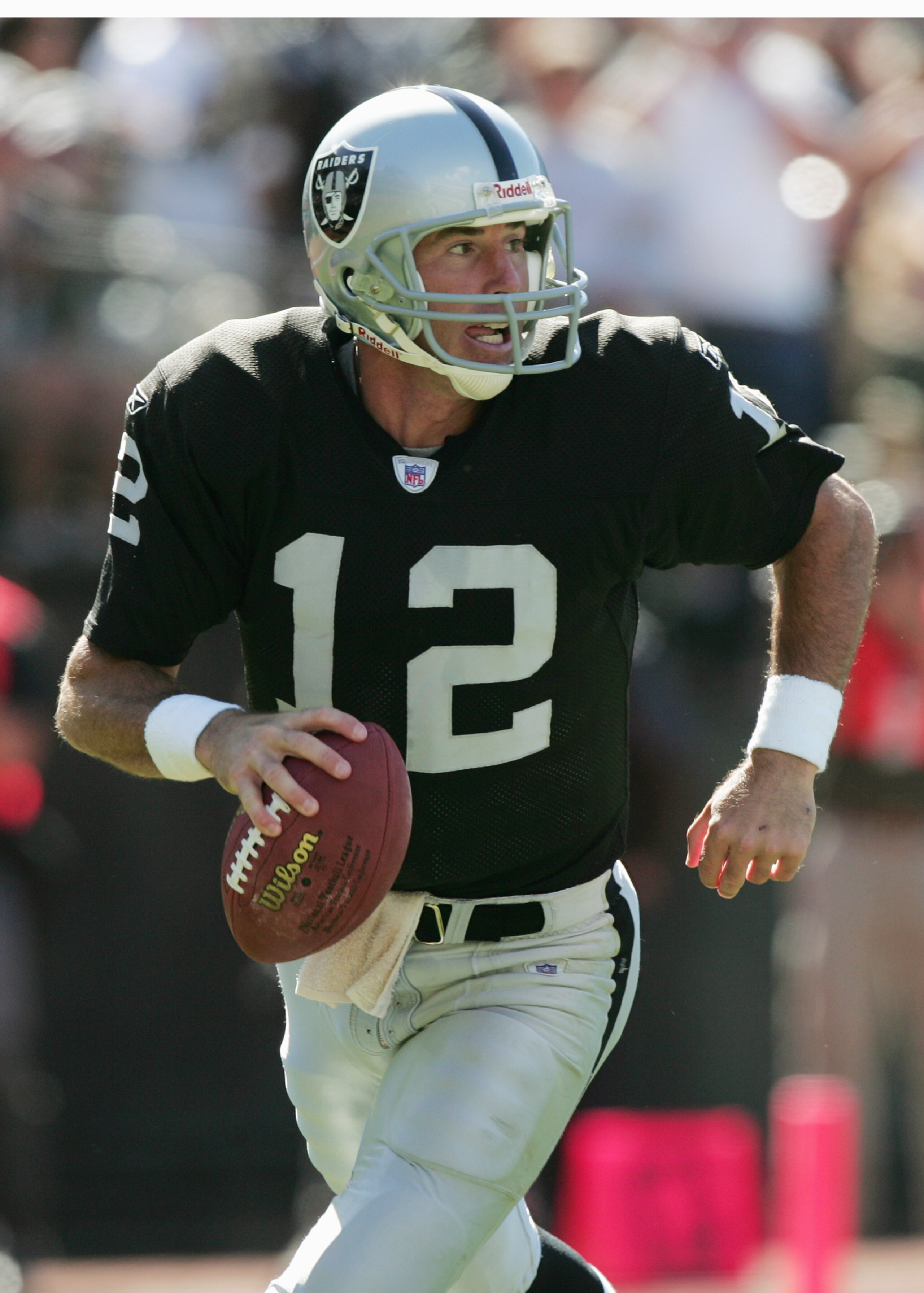 OAKLAND, CA - SEPTEMBER 19: Quarterback Rich Gannon #12 of the Oakland Raiders scrambles with the ball during the game against the Buffalo Bills at Network Associates Coliseum on September 19, 2004 in Oakland, California. The Raiders defeated the Bills 1 OAKLAND, CA - SEPTEMBER 19: Quarterback Rich Gannon #12 of the Oakland Raiders scrambles with the ball during the game against the Buffalo Bills at Network Associates Coliseum on September 19, 2004 in Oakland, California. The Raiders defeated the Bills 1