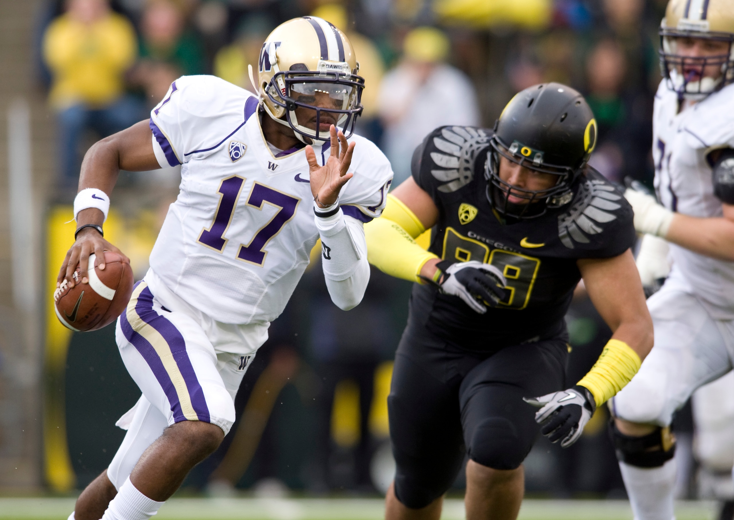 EUGENE, OR - NOVEMBER 6: Quarterback Keith Price #17 of the Washington Huskies is chased by defensive tackle Zac Clark #99 of the Oregon Ducks in the third quarter of the game at Autzen Stadium on November 6, 2010 in Eugene, Oregon. The Ducks won the game EUGENE, OR - NOVEMBER 6: Quarterback Keith Price #17 of the Washington Huskies is chased by defensive tackle Zac Clark #99 of the Oregon Ducks in the third quarter of the game at Autzen Stadium on November 6, 2010 in Eugene, Oregon. The Ducks won the game