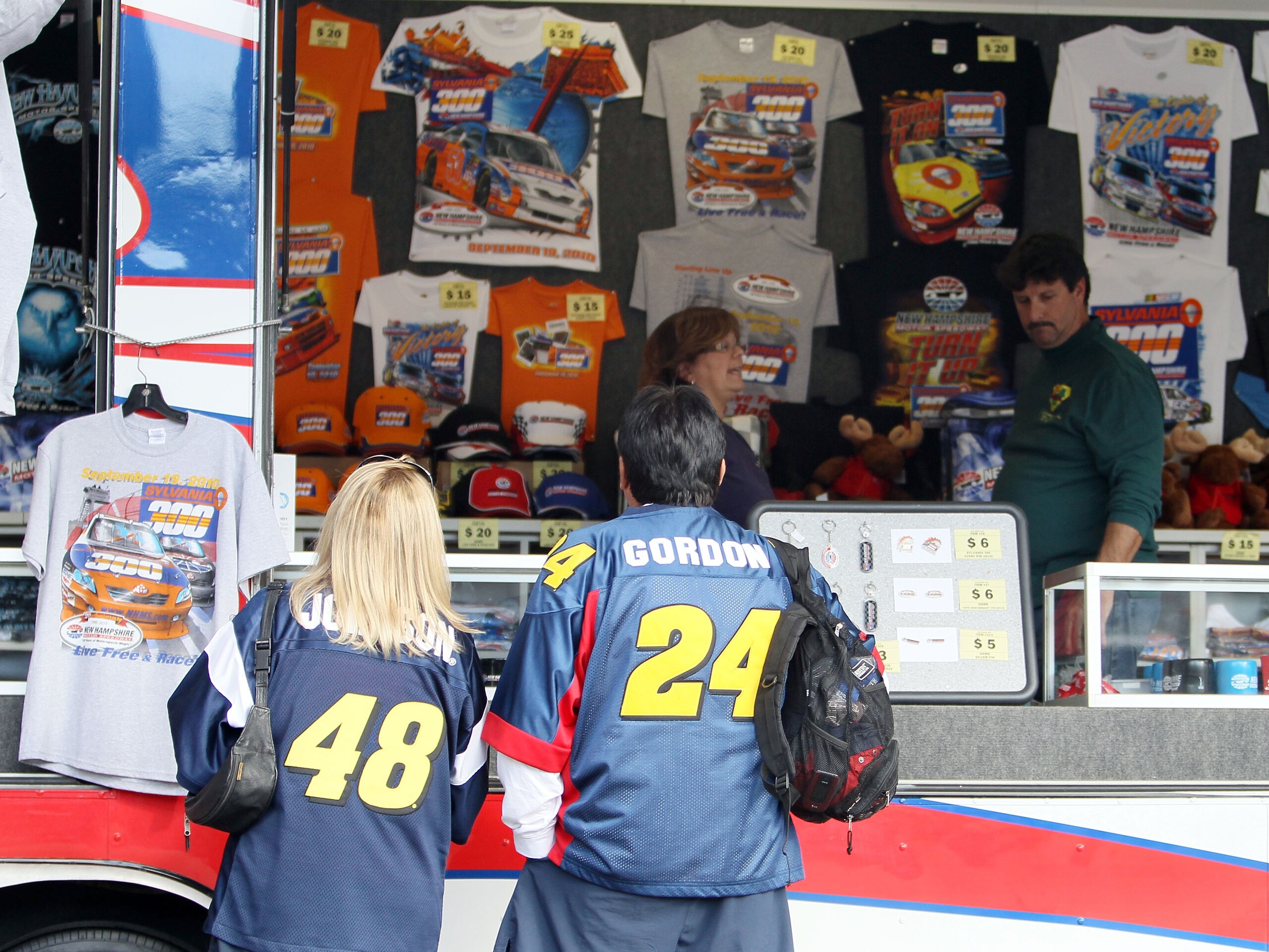 LOUDON, NH - SEPTEMBER 18:  Fans visit the merchandise trailer during the NASCAR Camping World Truck Series TheRaceDayRaffleSeries.com 175 at the New Hampshire Motor Speedway on September 18, 2010 in Loudon, New Hampshire.  (Photo by Elsa/Getty Images)