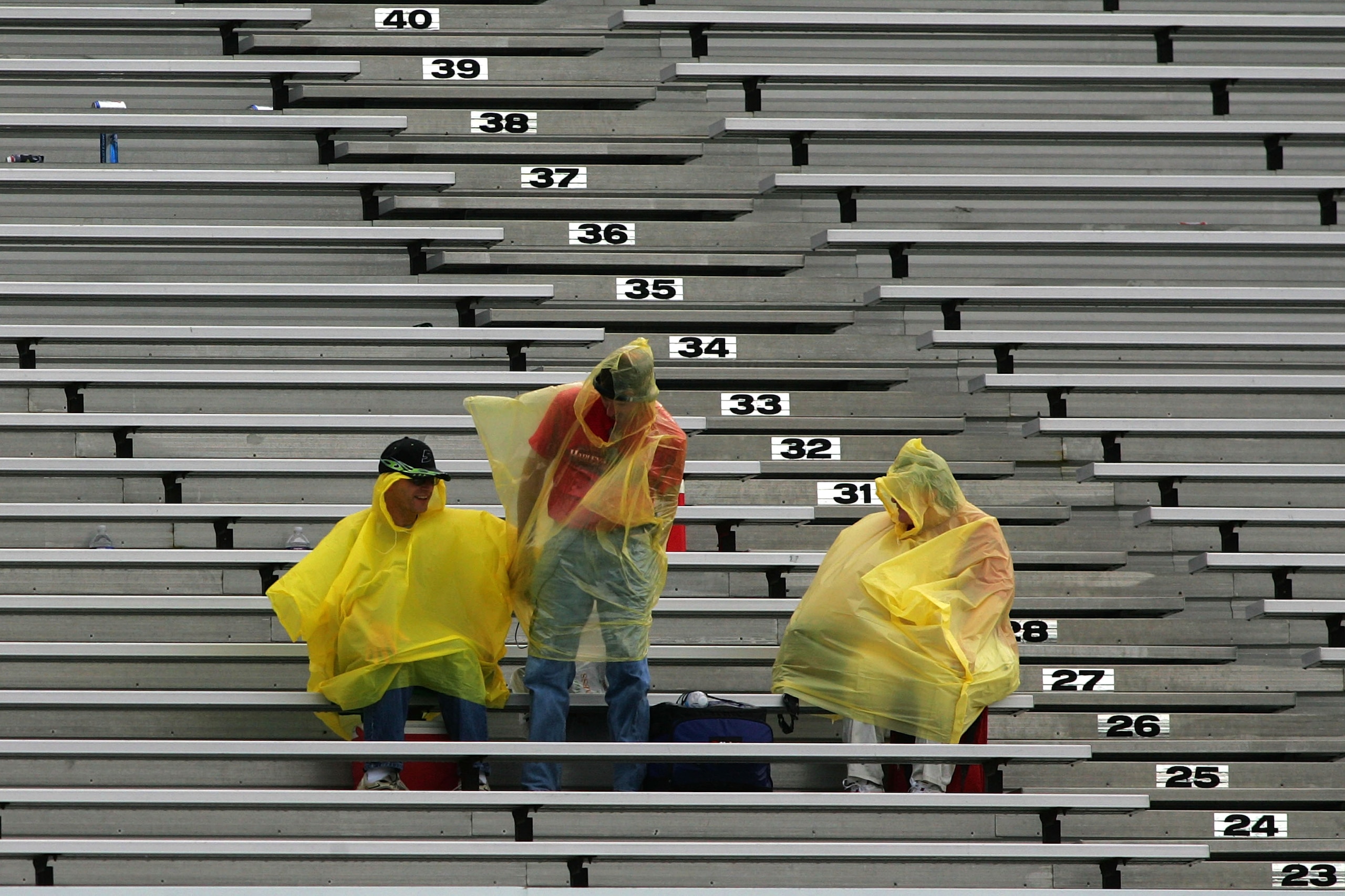 LONG POND, PA - JUNE 06:  Fans sit in the grandstands during a rain delay to the NASCAR Sprint Cup Series Gillette Fusion ProGlide 500 at Pocono Raceway on June 6, 2010 in Long Pond, Pennsylvania.  (Photo by Todd Warshaw/Getty Images)