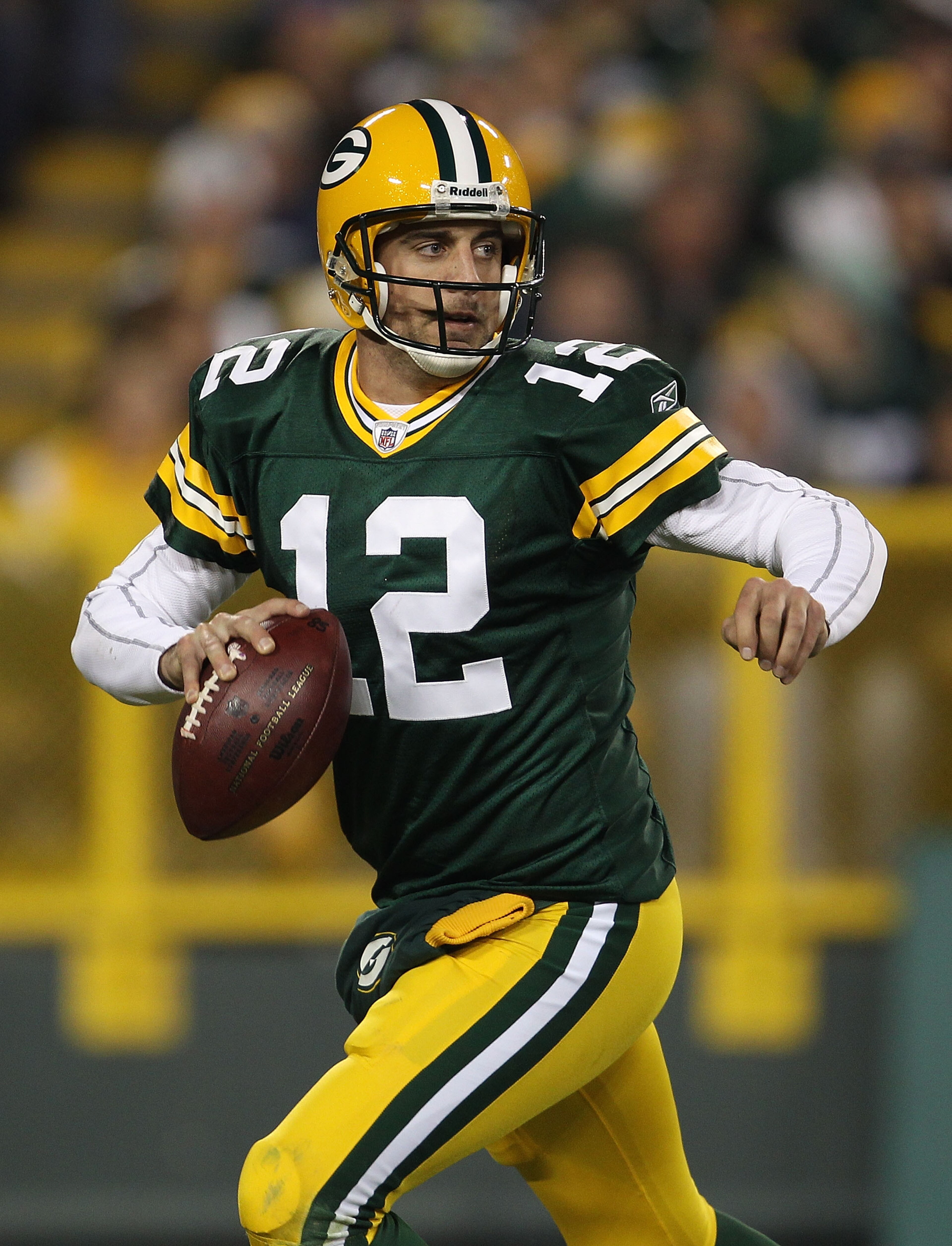 GREEN BAY, WI - NOVEMBER 07: Aaron Rodgers #12 of the Green Bay Packers rolls out to look for a receiver against the Dallas Cowboys at Lambeau Field on November 7, 2010 in Green Bay, Wisconsin. (Photo by Jonathan Daniel/Getty Images)
