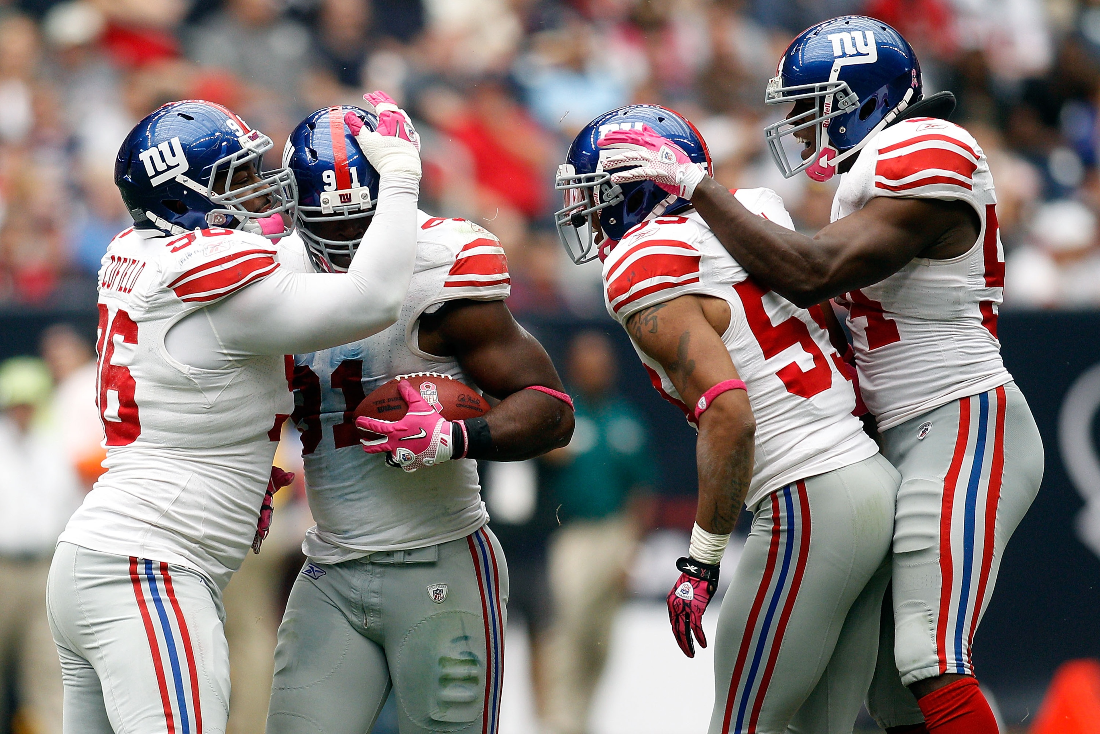 HOUSTON - OCTOBER 10:  Justin Tuck #91 of the New York Giants celebrates after recovering a fumble during the game against the Houston Texans at Reliant Stadium on October 10, 2010 in Houston, Texas.  The Giants defeated the Texans 34-10.  (Photo by Chris