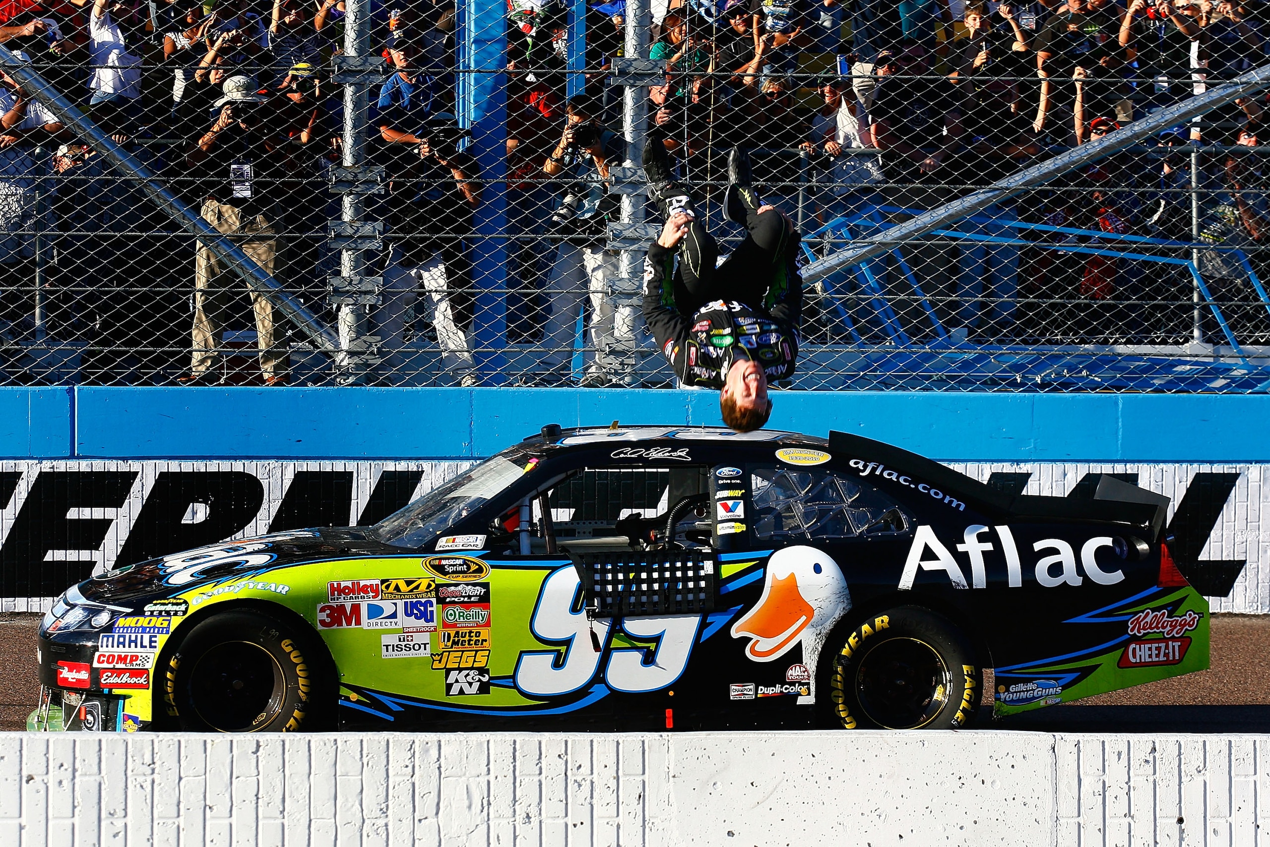 AVONDALE, AZ - NOVEMBER 14: Carl Edwards, driver of the #99 Aflac Ford, performs a backflip after winning the NASCAR Sprint Cup Series Kobalt Tools 500 at Phoenix International Raceway on November 14, 2010 in Avondale, Arizona. (Photo by Jason Smith/Get AVONDALE, AZ - NOVEMBER 14: Carl Edwards, driver of the #99 Aflac Ford, performs a backflip after winning the NASCAR Sprint Cup Series Kobalt Tools 500 at Phoenix International Raceway on November 14, 2010 in Avondale, Arizona. (Photo by Jason Smith/Get