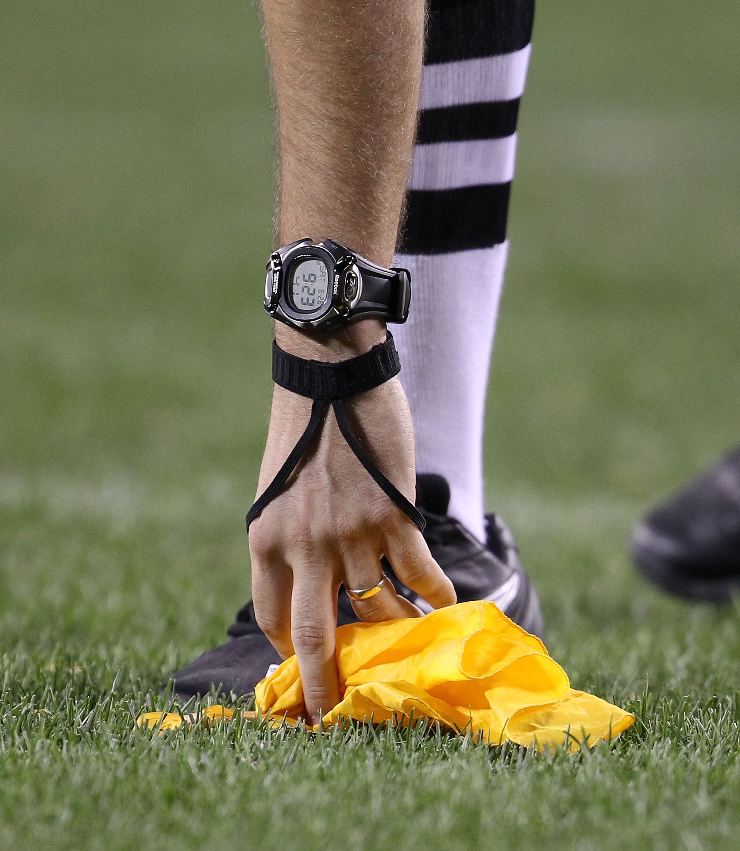 CHICAGO - AUGUST 28: A referee picks up a penalty flag during a preseason game between the Chicago Bears and the Arizona Cardinals during a preseason game at Soldier Field on August 28, 2010 in Chicago, Illinois. The Cardinals defeated the Bears 14-9. (Ph CHICAGO - AUGUST 28: A referee picks up a penalty flag during a preseason game between the Chicago Bears and the Arizona Cardinals during a preseason game at Soldier Field on August 28, 2010 in Chicago, Illinois. The Cardinals defeated the Bears 14-9. (Ph