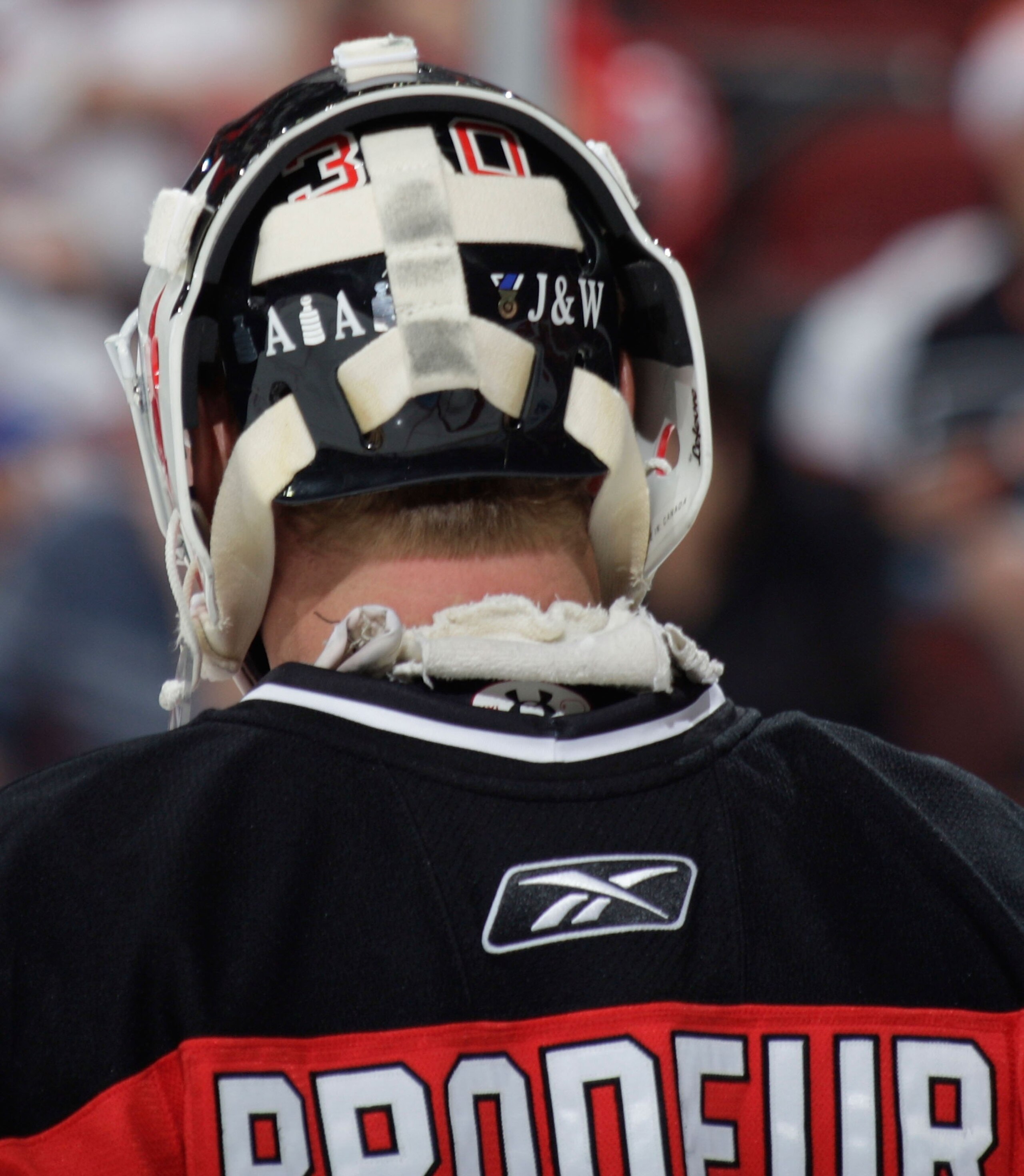 NEWARK, NJ - SEPTEMBER 26: The back of the mask worn by goaltender Martin Brodeur of the New Jersey Devils has the initials of his children on it. Photographed during a timeout against the Philadelphia Flyers on September 26, 2009 at the Prudential Center NEWARK, NJ - SEPTEMBER 26: The back of the mask worn by goaltender Martin Brodeur of the New Jersey Devils has the initials of his children on it. Photographed during a timeout against the Philadelphia Flyers on September 26, 2009 at the Prudential Center