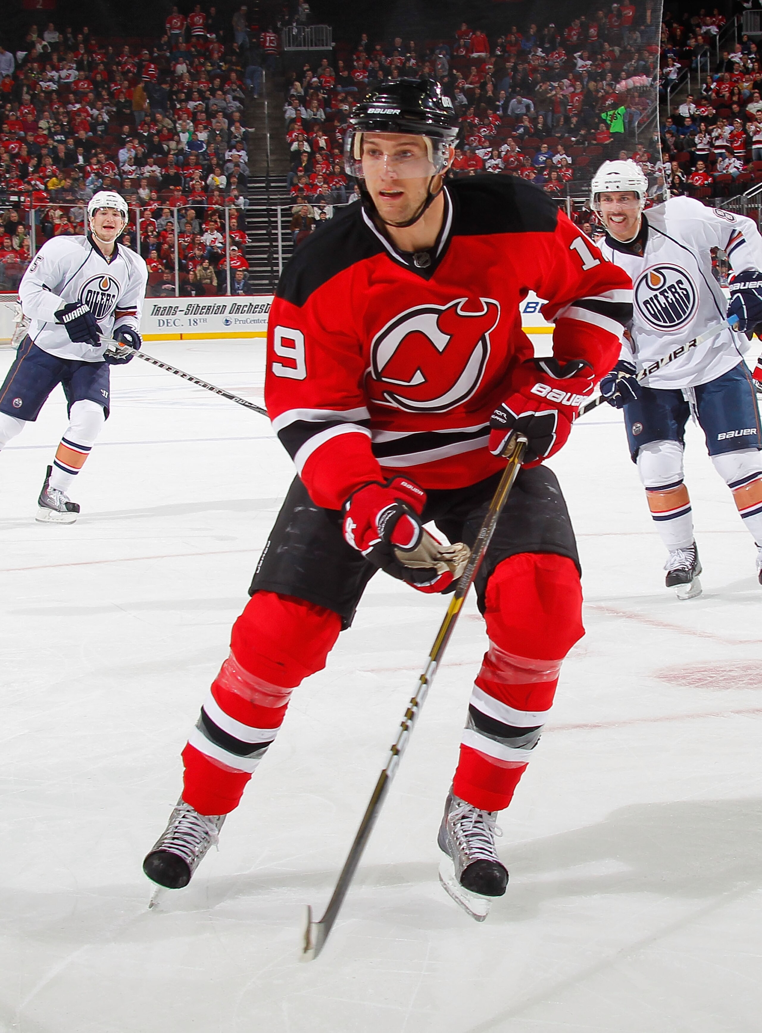 NEWARK, NJ - NOVEMBER 12:  Travis Zajac #19 of the New Jersey Devils watches the puck during a hockey game against the Edmonton Oilers at the Prudential Center on November 12, 2010 in Newark, New Jersey.  (Photo by Paul Bereswill/Getty Images)