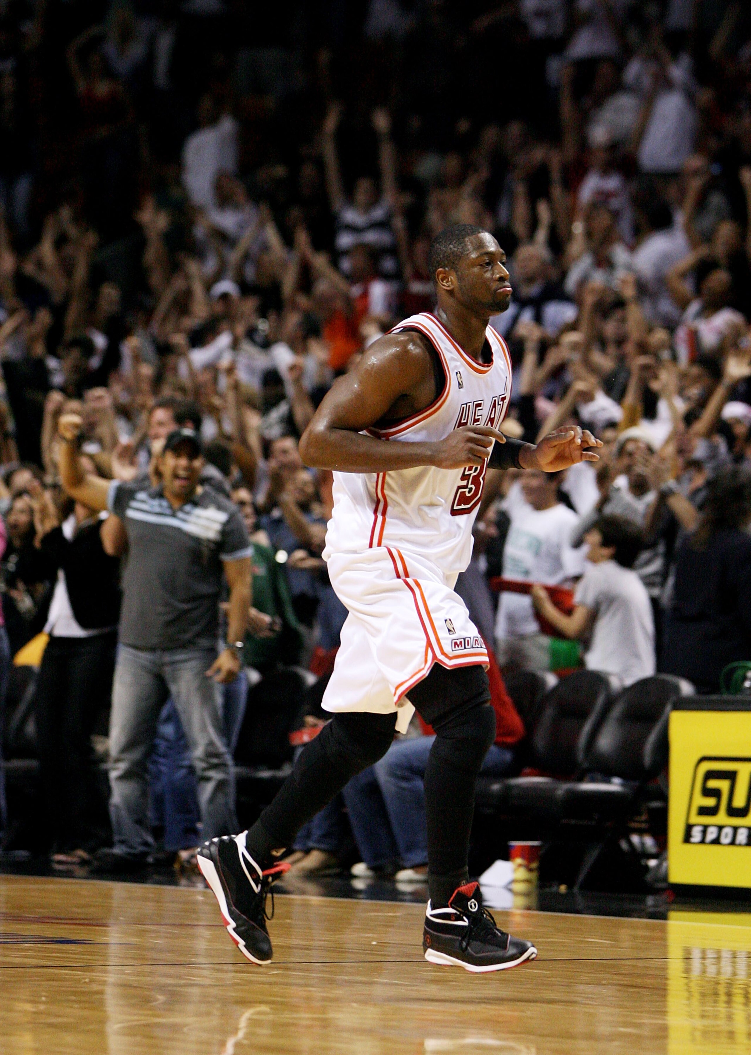 MIAMI - DECEMBER 22:  Dwyane Wade #3 of the Miami Heat celebrates after hitting the game-winning shot over Deron Williams #8 of the Utah Jazz at American Airlines Arena December 22, 2007 in Miami, Florida. The Heat defeated the Jazz 104-102. NOTE TO USER: