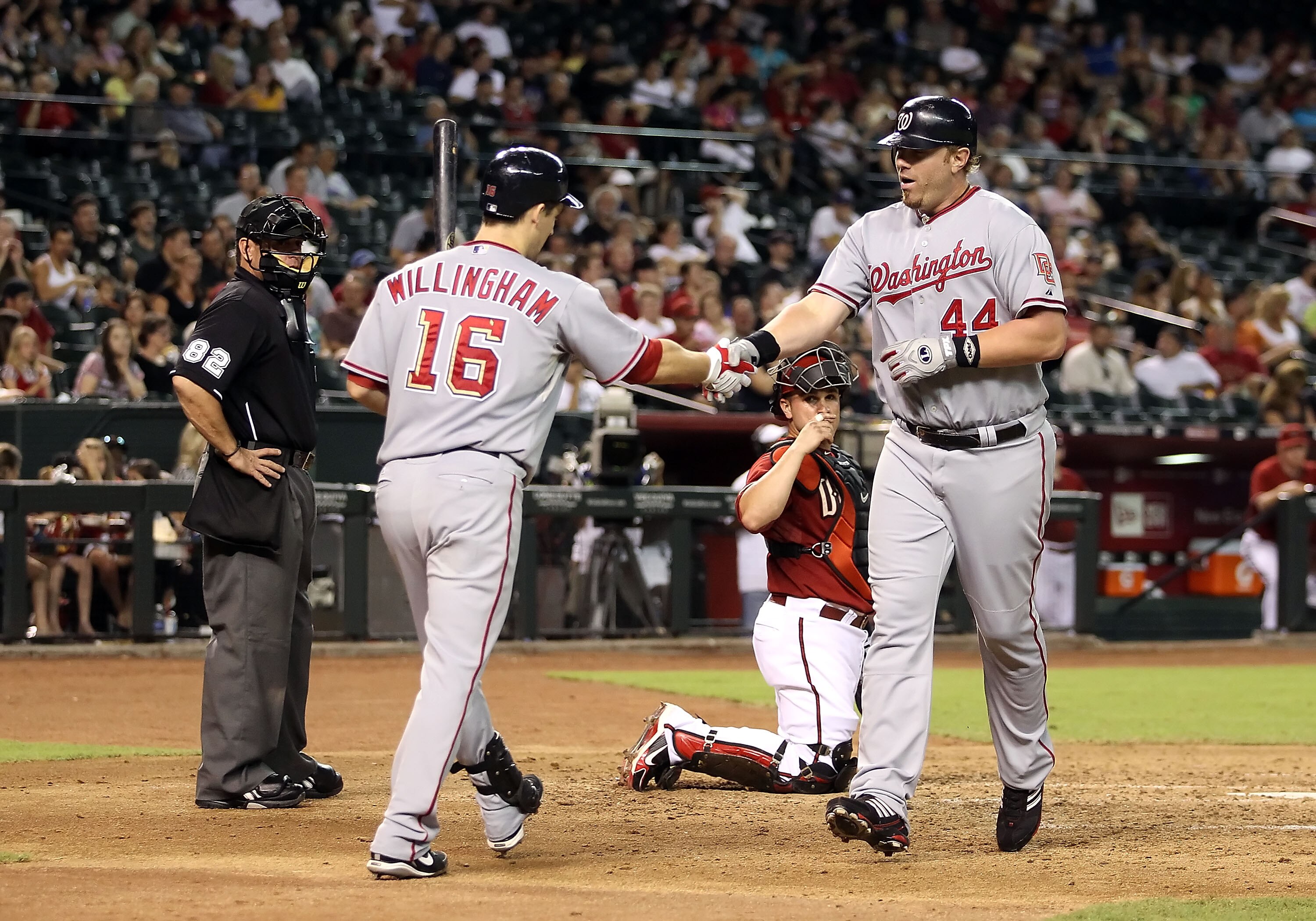 PHOENIX - AUGUST 04:  Adam Dunn #44 of the Washington Nationals is congratulated by teammate Josh Willingham #16 after hitting a solo home run against the Arizona Diamondbacks during the fourth inning of the Major League Baseball game at Chase Field on Au