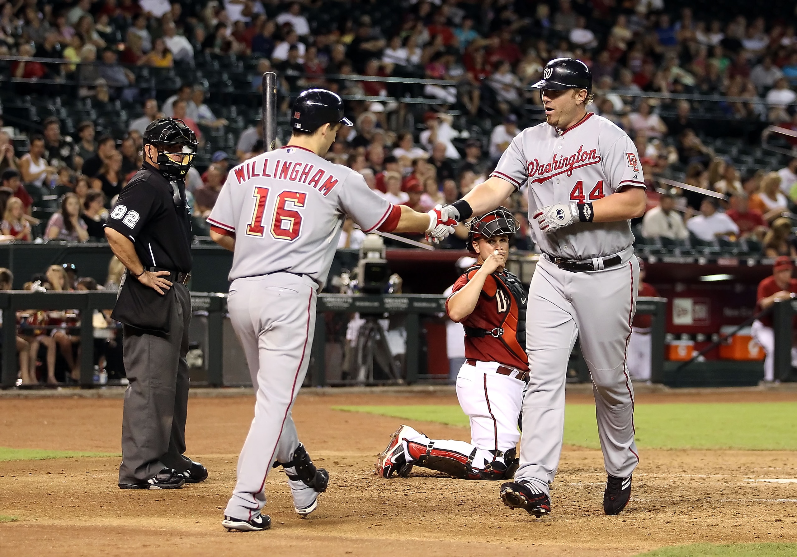 PHOENIX - AUGUST 04:  Adam Dunn #44 of the Washington Nationals is congratulated by teammate Josh Willingham #16 after hitting a solo home run against the Arizona Diamondbacks during the fourth inning of the Major League Baseball game at Chase Field on Au