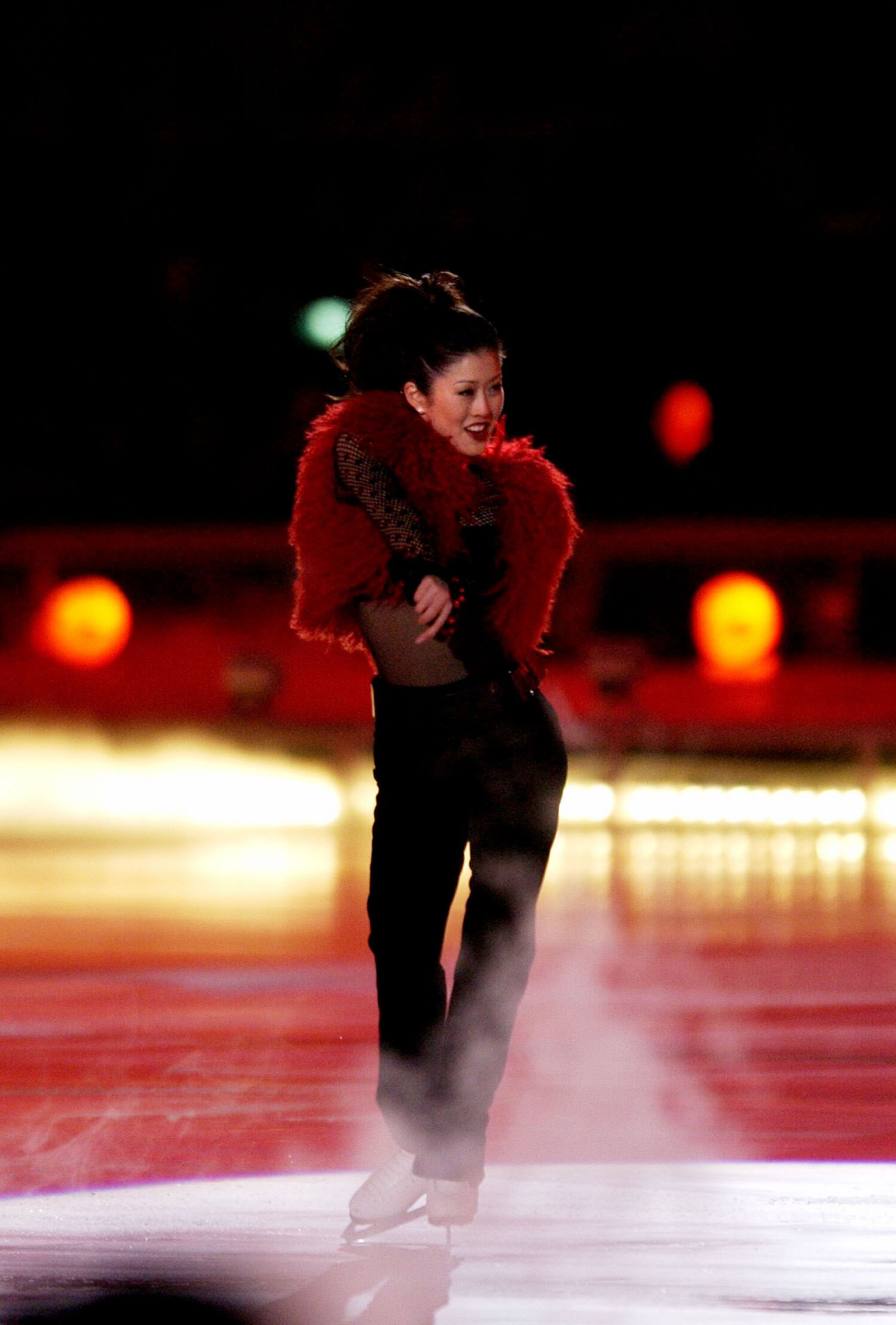 401509 12: (NEWSWEEK, US NEWS, MACLEANS, ITALY AND GERMANY OUT) Former olympic skating champion Kristi Yamaguchi performs during the Closing Ceremony of the Salt Lake City Winter Olympic Games at the Rice-Eccles Olympic Stadium February 24, 2002 in Salt L