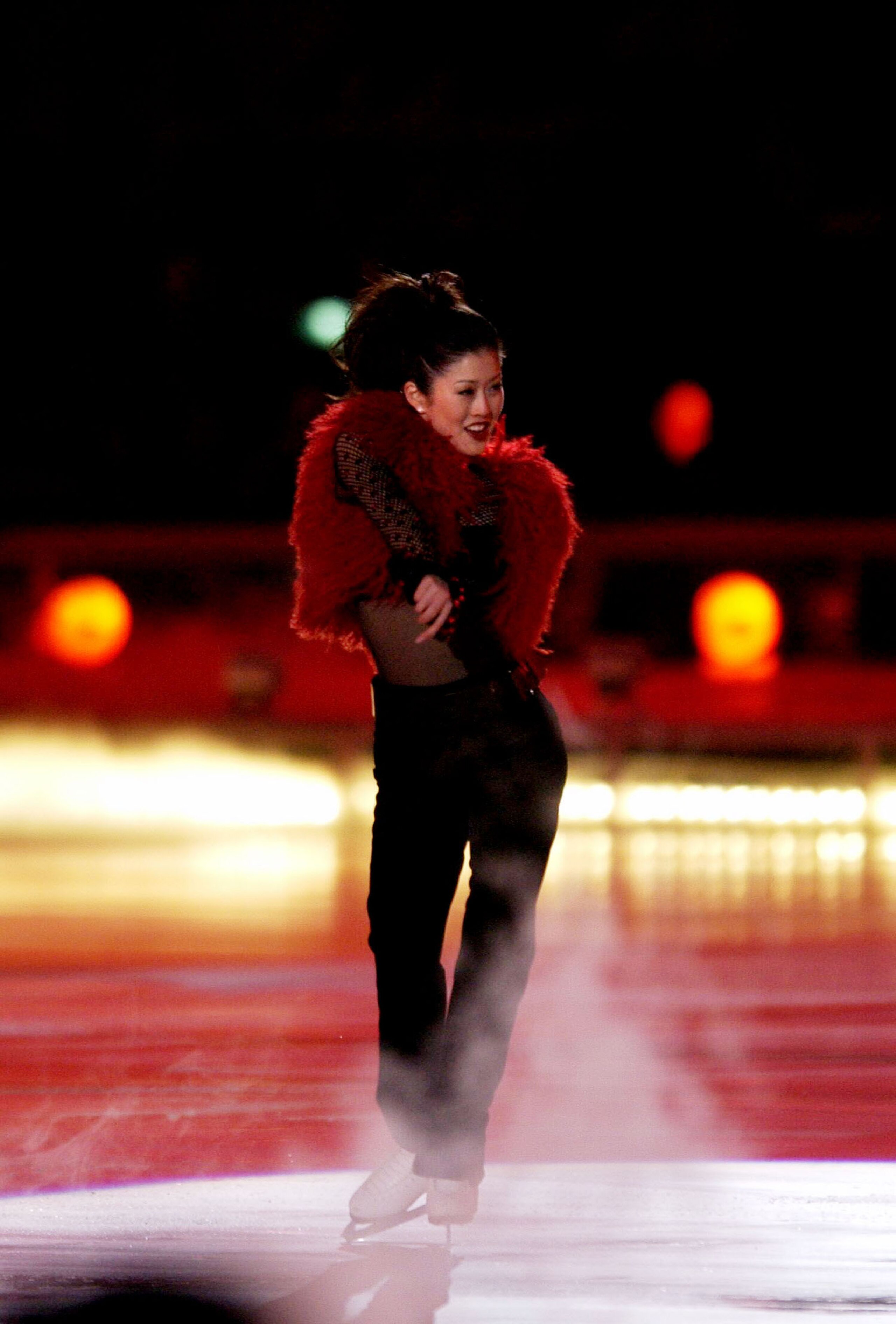 401509 12: (NEWSWEEK, US NEWS, MACLEANS, ITALY AND GERMANY OUT) Former olympic skating champion Kristi Yamaguchi performs during the Closing Ceremony of the Salt Lake City Winter Olympic Games at the Rice-Eccles Olympic Stadium February 24, 2002 in Salt L