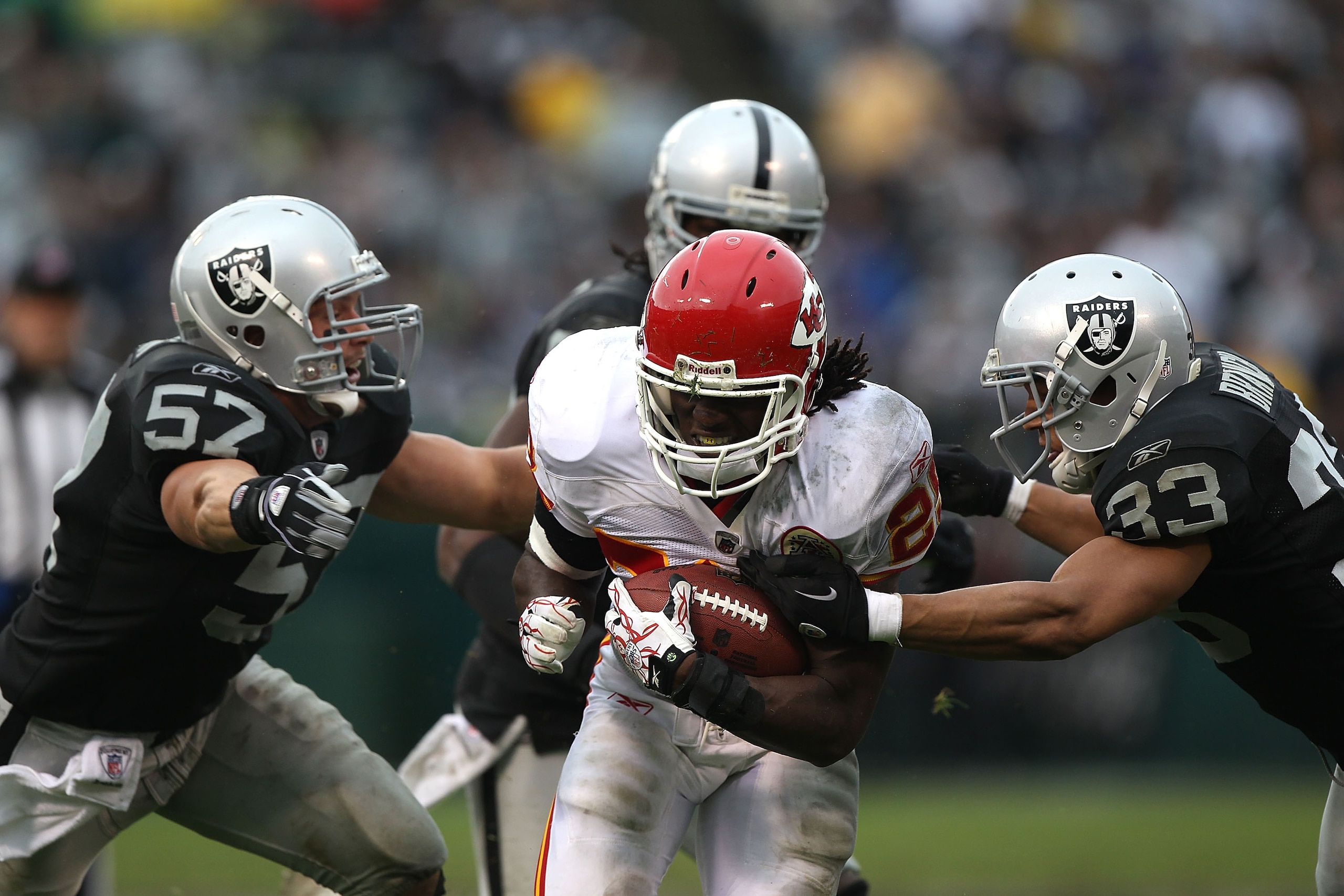 OAKLAND, CA - NOVEMBER 07:  Jamaal Charles #25 of the Kansas City Chiefs runs against Tyvon Branch #33 and Ricky Brown #57 of the Oakland Raiders during an NFL game at Oakland-Alameda County Coliseum on November 7, 2010 in Oakland, California.  (Photo by 