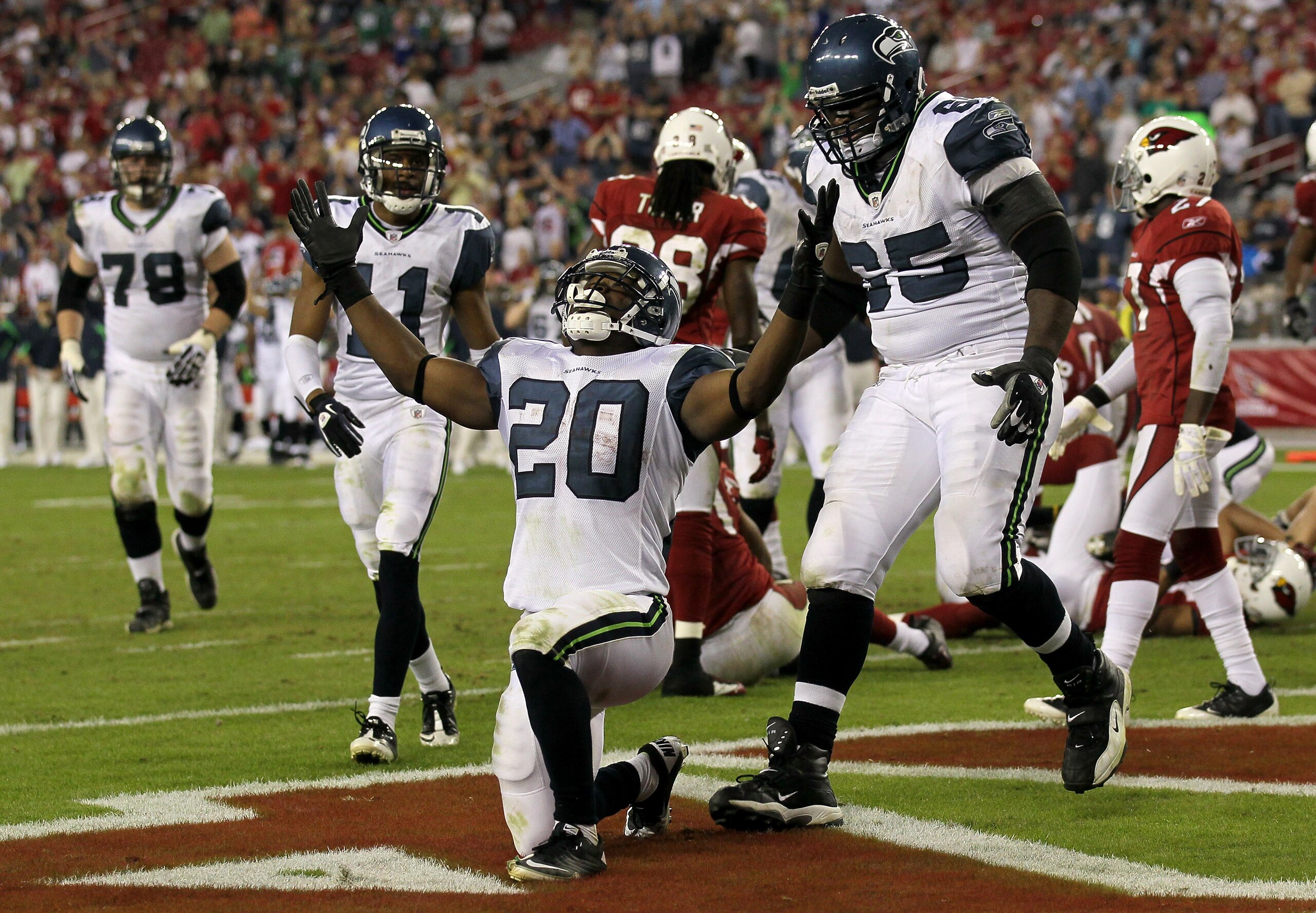 GLENDALE, AZ - NOVEMBER 14:  Running back Justin Forsett #20 of the Seattle Seahawks celebrates his four yard touchdown carry with center Chris Spencer #65 against the Arizona Cardinals in the fourth quarter at University of Phoenix Stadium on November 14