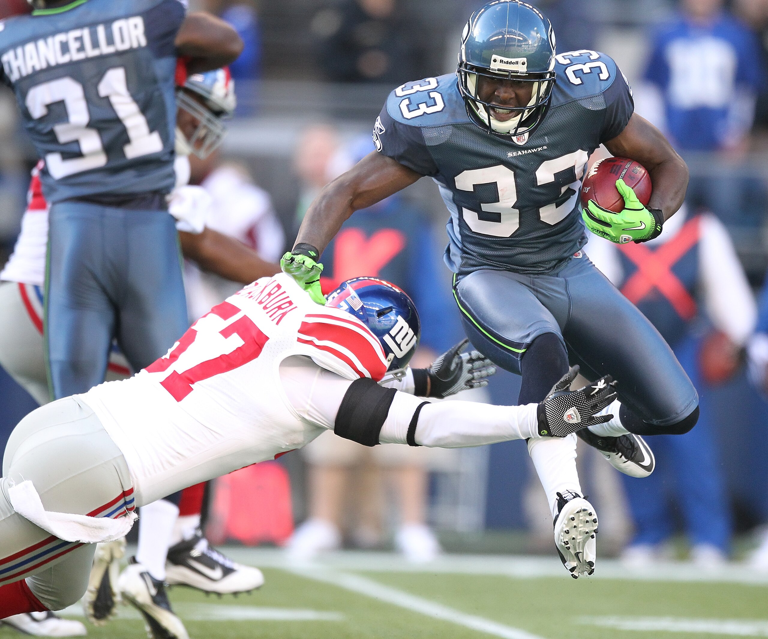 SEATTLE - NOVEMBER 07:  Leon Washington #33 of the Seattle Seahawks is tackled on a kick return by Chase Blackburn #57 of the New York Giants at Qwest Field on November 7, 2010 in Seattle, Washington. The Giants defeated the Seahawks 41-7. (Photo by Otto