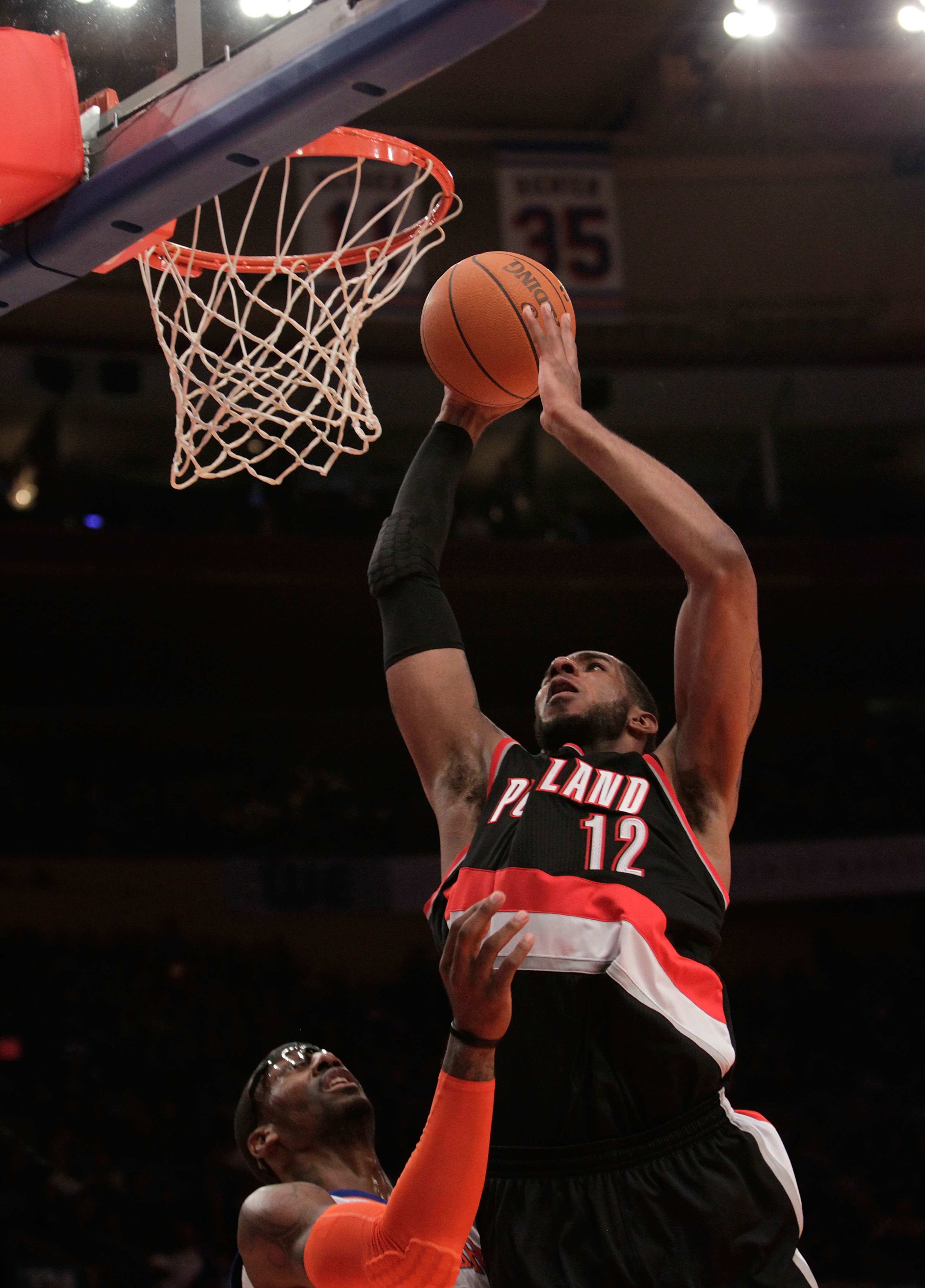 NEW YORK - OCTOBER 30:  LaMarcus Aldridge #12 of the Portland Trail Blazers dunks over Amar'e Stoudemire #1 of the New York Knicks at Madison Square Garden on October 30, 2010 in New York City. NOTE TO USER: User expressly acknowledges and agrees that, by