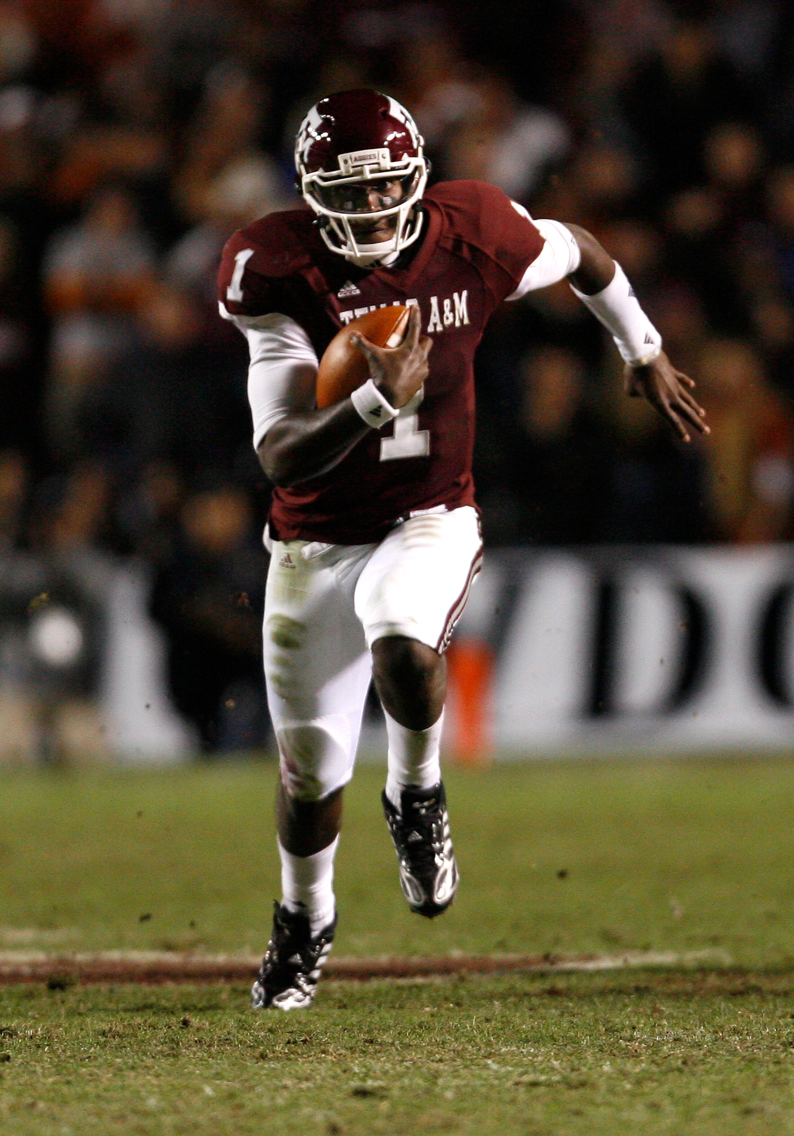 COLLEGE STATION, TX - NOVEMBER 26: Quarterback Jerrod Johnson #1 of the Texas A&M Aggies scrambles for a gain against the Texas Longhorns in the second half at Kyle Field on November 26, 2009 in College Station, Texas. The Longhorns defeated the Aggies 49