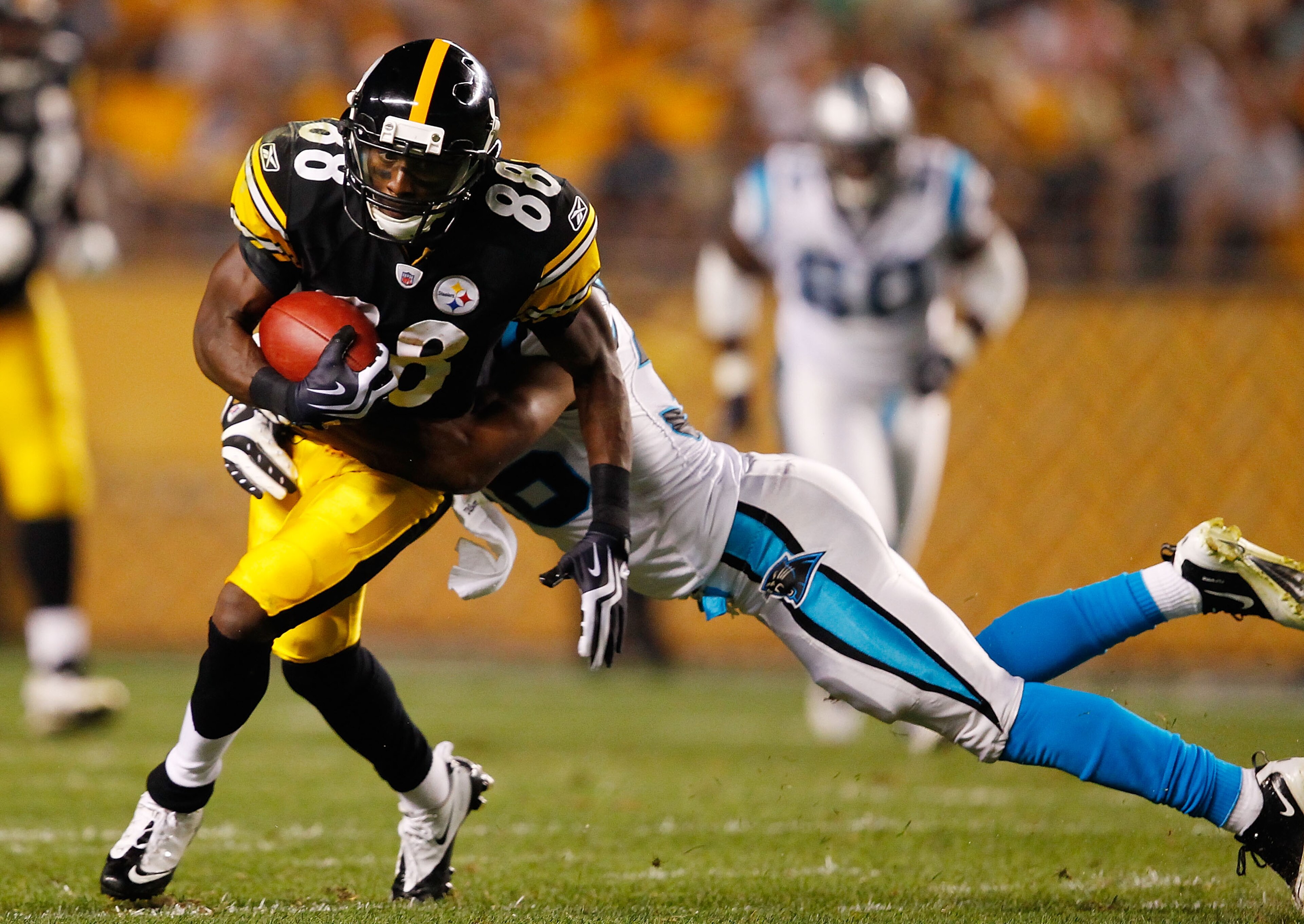 PITTSBURGH - SEPTEMBER 02:  Emmanuel Sanders #88 of the Pittsburgh Steelers runs by a defender after catching a pass against the Carolina Panthers during the preseason game on September 2, 2010 at Heinz Field in Pittsburgh, Pennsylvania.  (Photo by Jared 