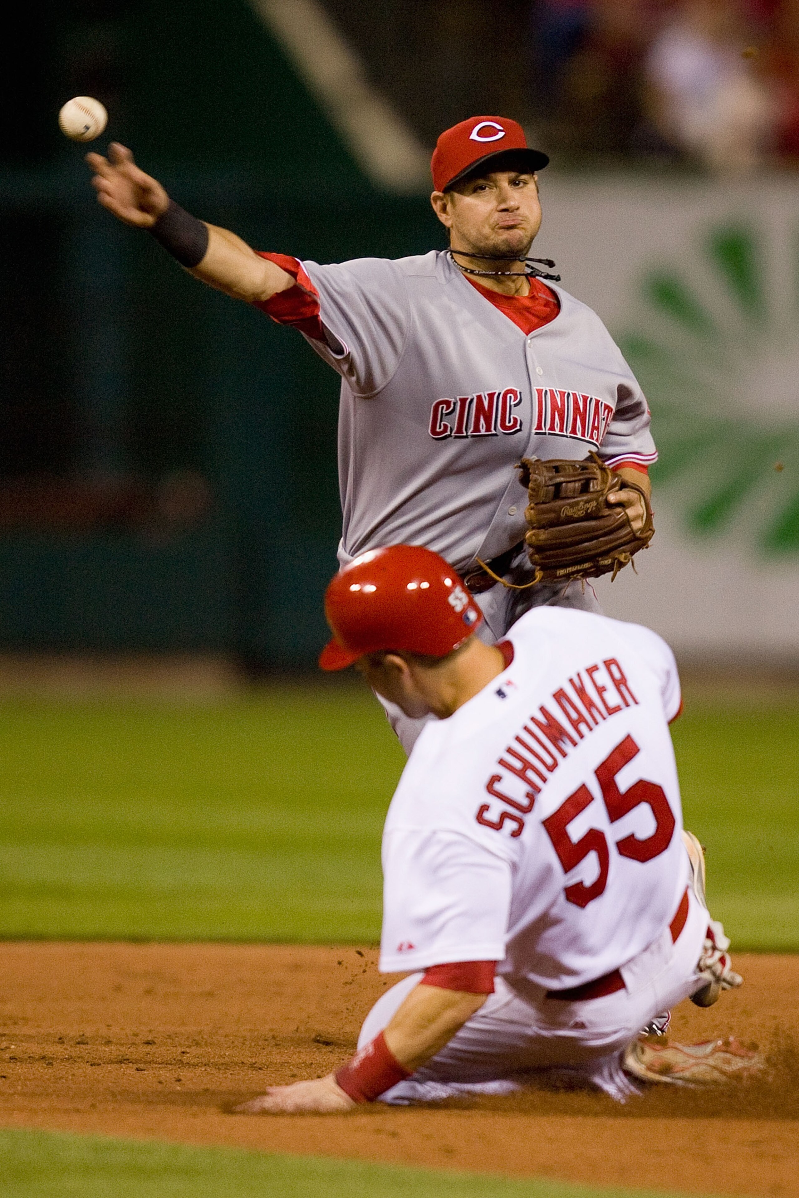 ST. LOUIS - SEPTEMBER 3: Paul Janish #7 of the Cincinnati Reds turns a double play over Skip Schumaker #55 of the St. Louis Cardinals at Busch Stadium on September 3, 2010 in St. Louis, Missouri. The Cardinals beat the Reds 3-2. (Photo by Dilip Vishwana ST. LOUIS - SEPTEMBER 3: Paul Janish #7 of the Cincinnati Reds turns a double play over Skip Schumaker #55 of the St. Louis Cardinals at Busch Stadium on September 3, 2010 in St. Louis, Missouri. The Cardinals beat the Reds 3-2. (Photo by Dilip Vishwana