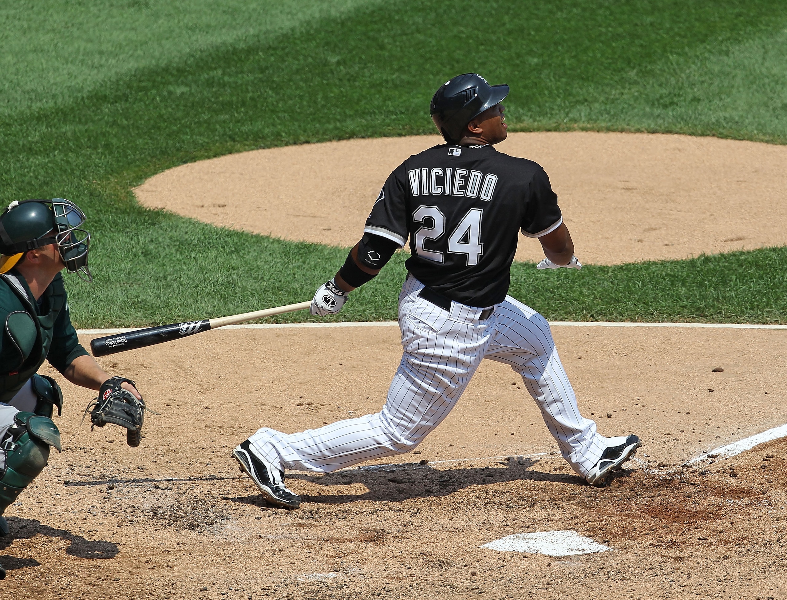CHICAGO - AUGUST 01: Dayan Viciedo #24 of the Chicago White Sox hits the ball against the Oakland Athletics at U.S. Cellular Field on August 1, 2010 in Chicago, Illinois. The White Sox defeated the Athletics 4-1. (Photo by Jonathan Daniel/Getty Images) CHICAGO - AUGUST 01: Dayan Viciedo #24 of the Chicago White Sox hits the ball against the Oakland Athletics at U.S. Cellular Field on August 1, 2010 in Chicago, Illinois. The White Sox defeated the Athletics 4-1. (Photo by Jonathan Daniel/Getty Images)