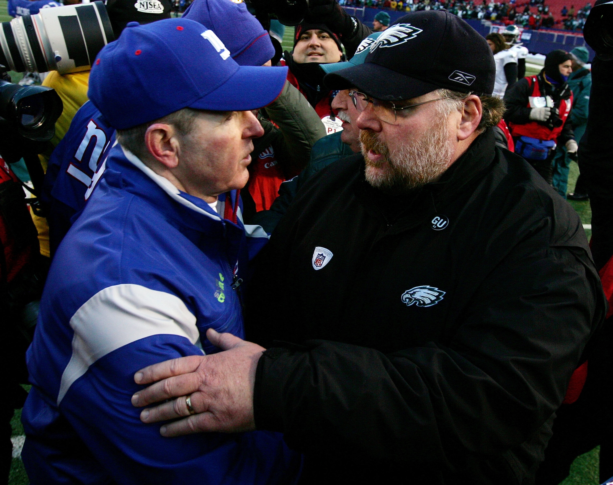 EAST RUTHERFORD, NJ - JANUARY 11:  Head coach Tom Coughlin #10 of the New York Giants shakes hands with head coach Andy Reid of the Philadelphia Eagles after the NFC Divisional Playoff Game on January 11, 2009 at Giants Stadium in East Rutherford, New Jer