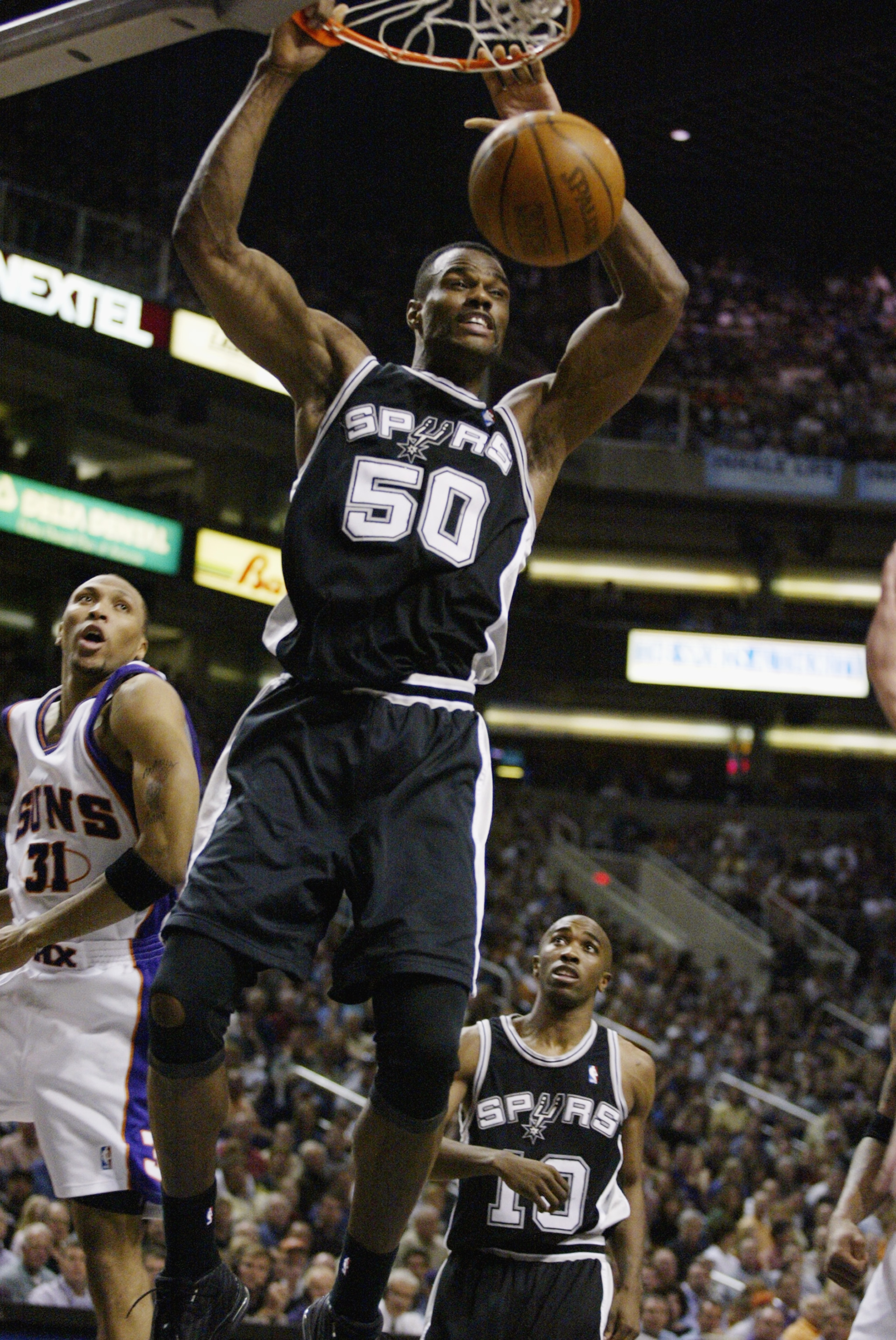 PHOENIX,  AZ - APRIL 25:  David Robinson #50 of the San Antonio Spurs slam dunks in Game three of the Western Conference Quarterfinals against the Phoenix Suns during the 2003 NBA Playoffs at America West Arena on April 25, 2003 in Phoenix, Arizona.  The