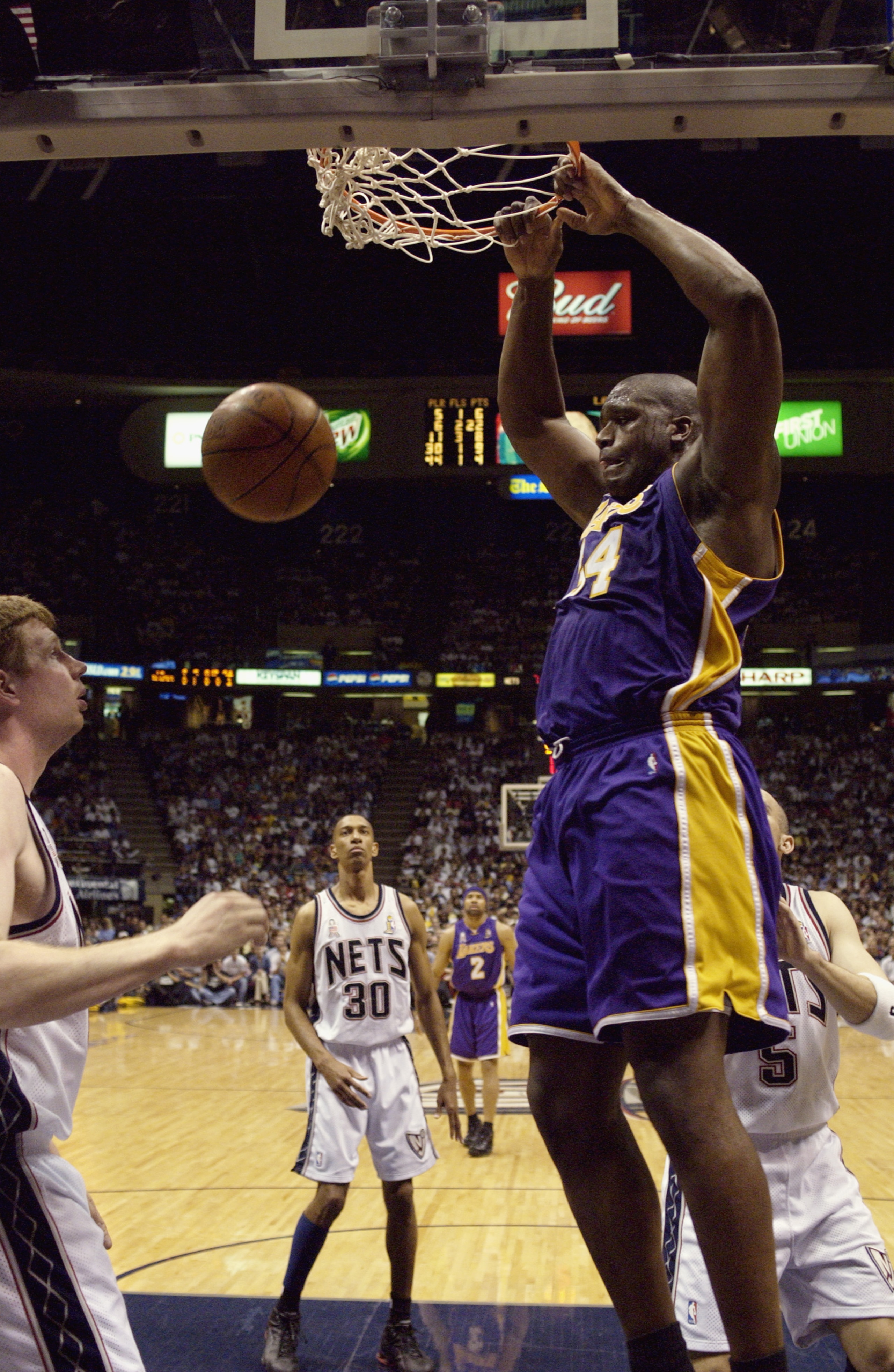 EAST RUTHERFORD, NJ - JUNE 12: Shaquille O'Neal #34 of the Los Angeles Lakers slam dunks in Game four of the 2002 NBA Finals against the New Jersey Nets at Continental Airlines Arena in East Rutherford, New Jersey on June 12, 2002. The Lakers won 112-106