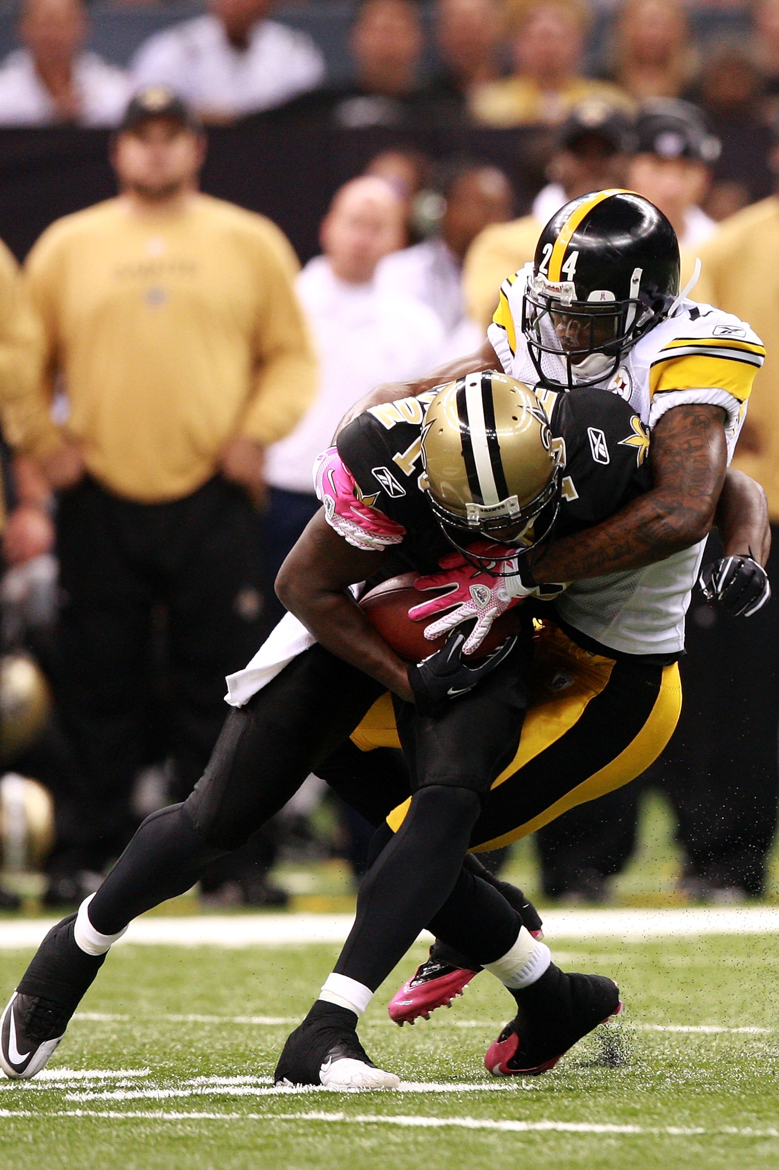 NEW ORLEANS - OCTOBER 31:  Ike Taylor #24 of the Pittsburgh Steelers tackles Marques Colston #12 of the New Orleans Saints at Louisiana Superdome on October 31, 2010 in New Orleans, Louisiana.  The Saints won 20-10 over the Steelers.  (Photo by Karl Walte