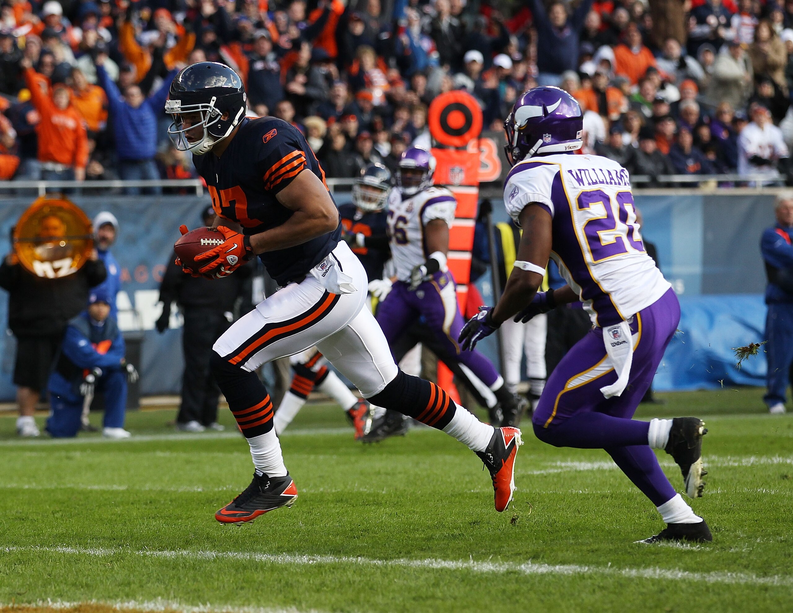 CHICAGO - NOVEMBER 14: Kellen Davis #87 of the Chicago Bears runs into the end zone for a touchdown pursued by Madieu Williams #20 of the Minnesota Vikings at Soldier Field on November 14, 2010 in Chicago, Illinois. The Bears defeated the Vikings 27-13. (