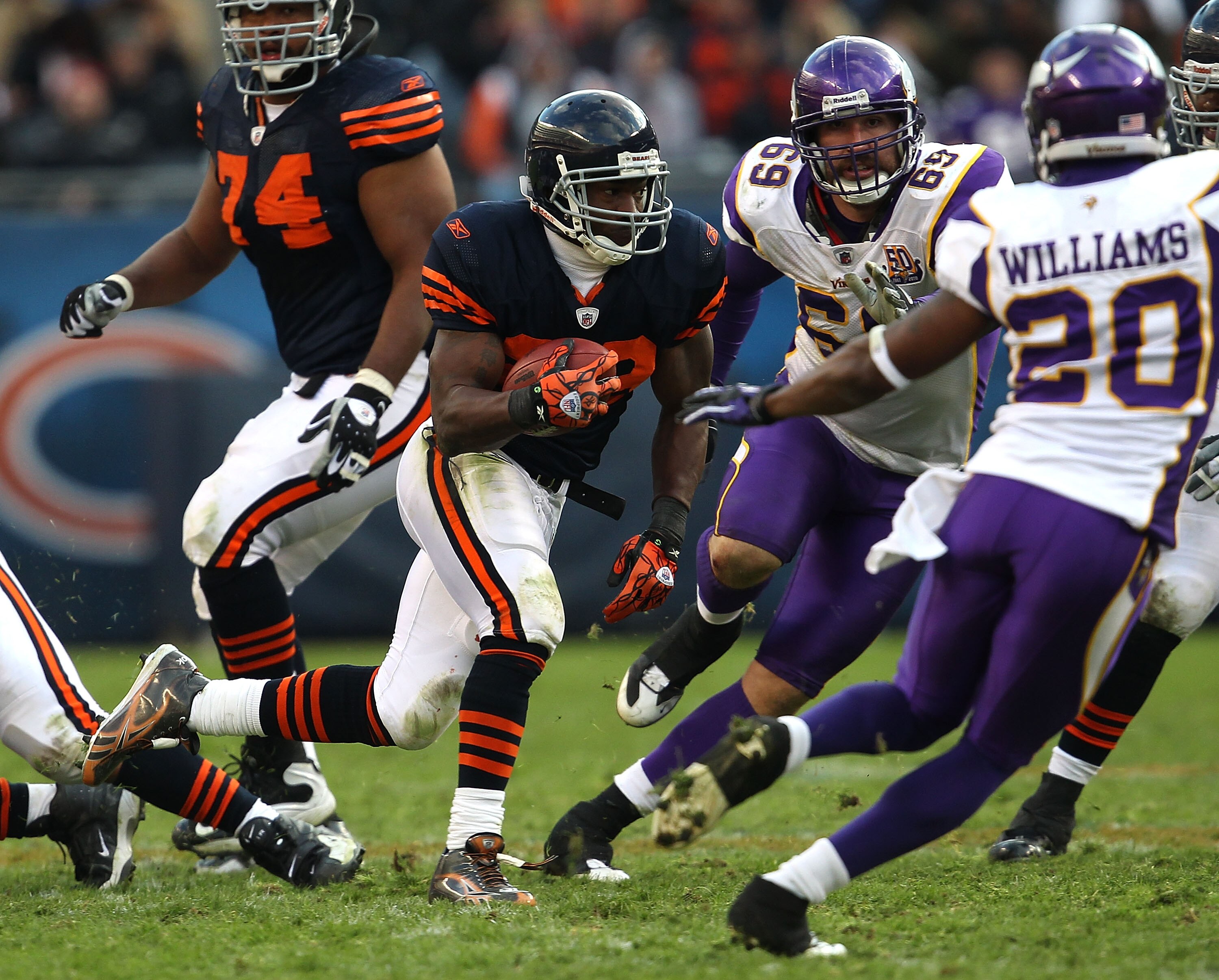 CHICAGO - NOVEMBER 14: Chester Taylor #29 of the Chicago Bears runs against Jared Allen #69 and Madieu Williams #20 of the Minnesota Vikings at Soldier Field on November 14, 2010 in Chicago, Illinois. The Bears defeated the Vikings 27-13. (Photo by Jonath
