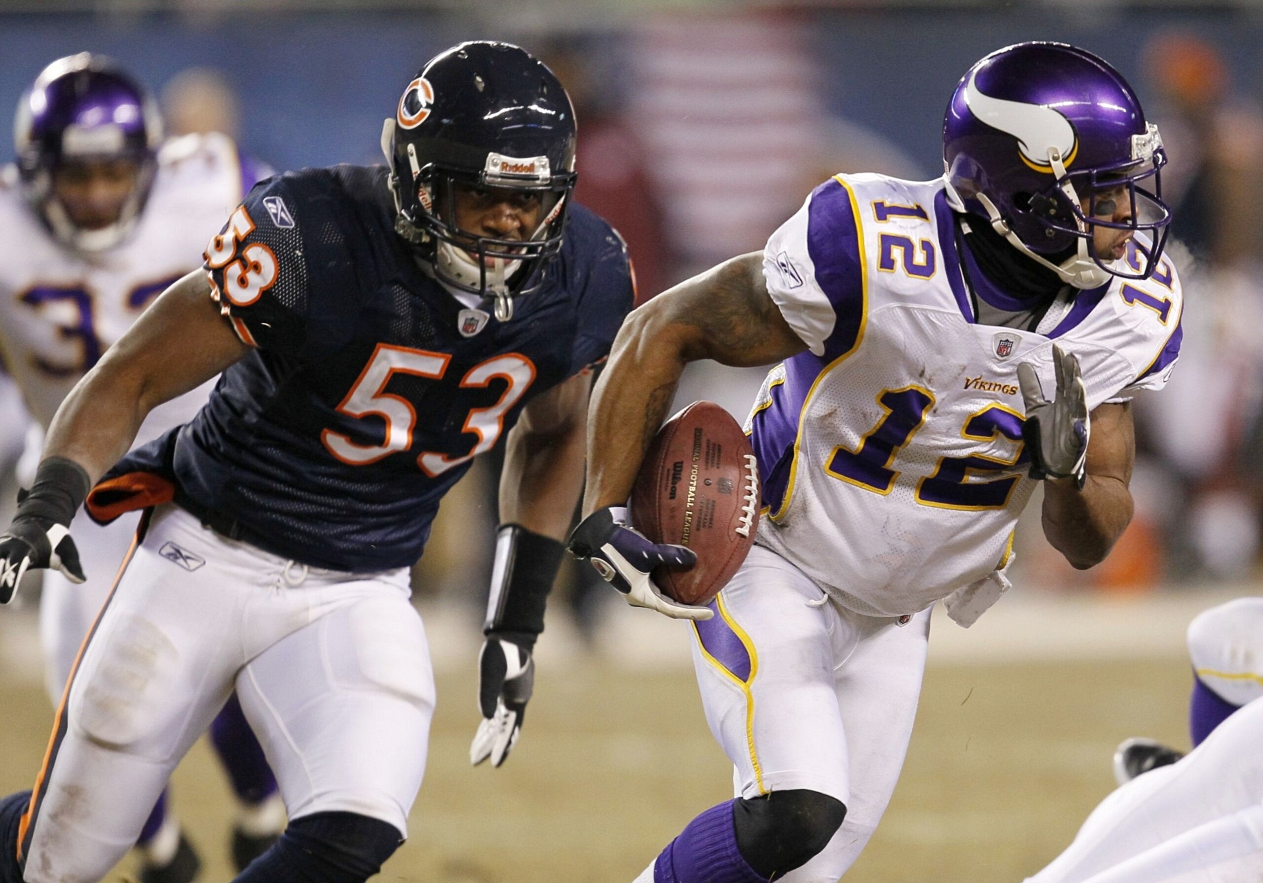 CHICAGO - DECEMBER 28:  Percy Harvin #12 of the Minnesota Vikings runs the ball as he is being chased by Nick Roach #53 of the Chicago Bears in the third quarter at Soldier Field on December 28, 2009 in Chicago, Illinois. (Photo by Jonathan Daniel/Getty I