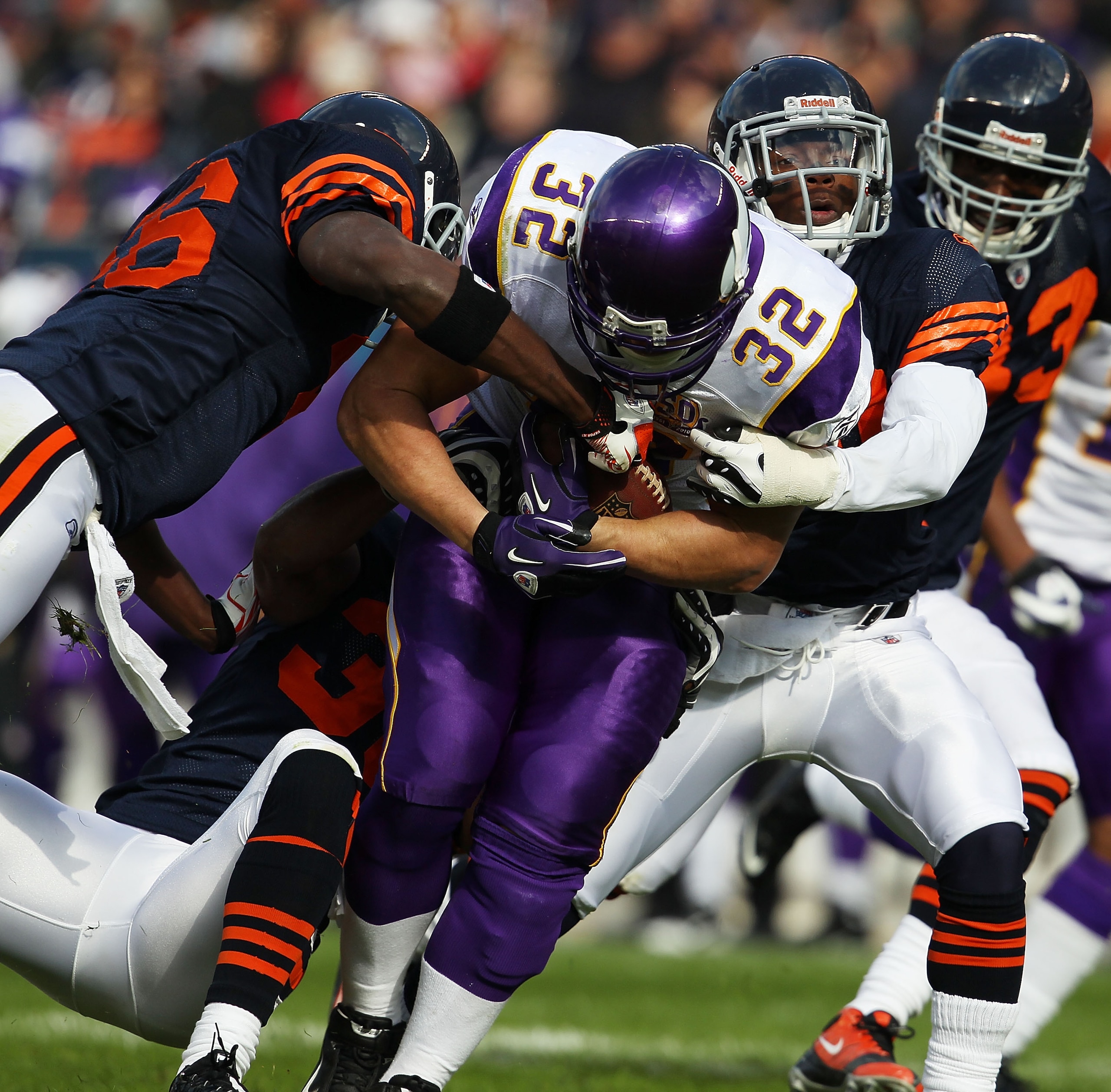 CHICAGO - NOVEMBER 14: Toby Gerhart #32 of the Minnesota Vikings is tackled by (L-R) Tim Jennings #26, Danieal Manning #38 and Chris Harris #46 of the Chicago Bears at Soldier Field on November 14, 2010 in Chicago, Illinois. The Bears defeated the Vikings