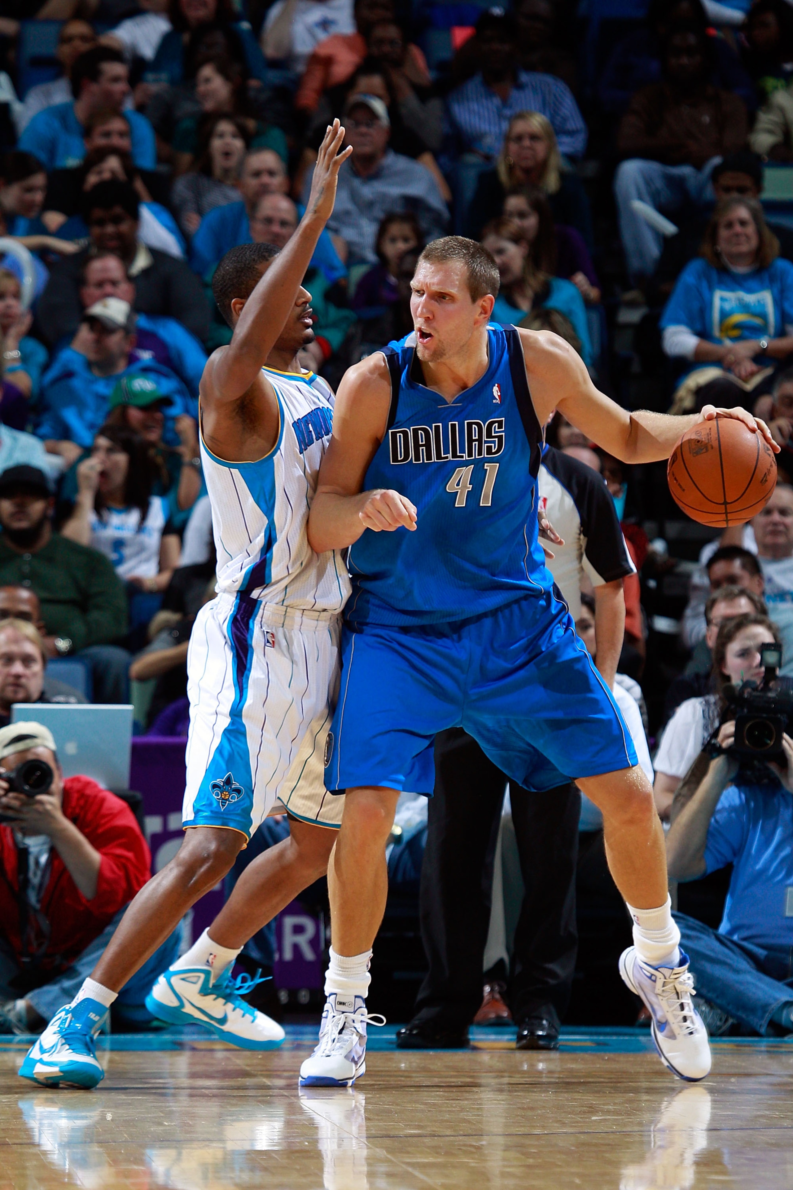 NEW ORLEANS - NOVEMBER 17:  Dirk Nowitzki #41 of the Dallas Mavericks drives the ball around Trevor Ariza #1 of the New Orleans Hornets at the New Orleans Arena on November 17, 2010 in New Orleans, Louisiana.  The Hornets defeated the Mavericks 99-97.  NO