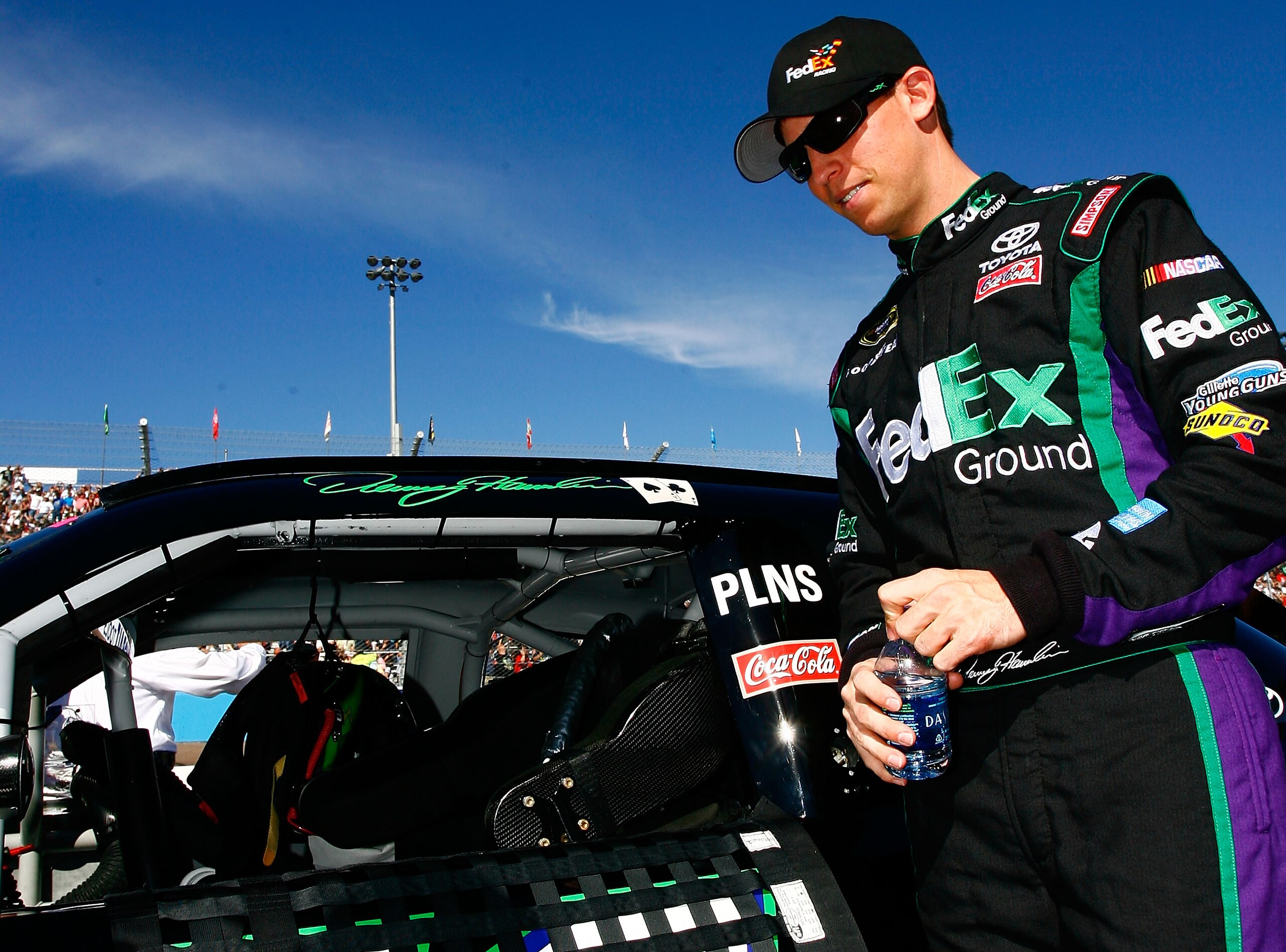 AVONDALE, AZ - NOVEMBER 14: Denny Hamlin, driver of the #11 FedEx Toyota, stands by his car prior to the NASCAR Sprint Cup Series Kobalt Tools 500 at Phoenix International Raceway on November 14, 2010 in Avondale, Arizona. (Photo by Jason Smith/Getty Im AVONDALE, AZ - NOVEMBER 14: Denny Hamlin, driver of the #11 FedEx Toyota, stands by his car prior to the NASCAR Sprint Cup Series Kobalt Tools 500 at Phoenix International Raceway on November 14, 2010 in Avondale, Arizona. (Photo by Jason Smith/Getty Im