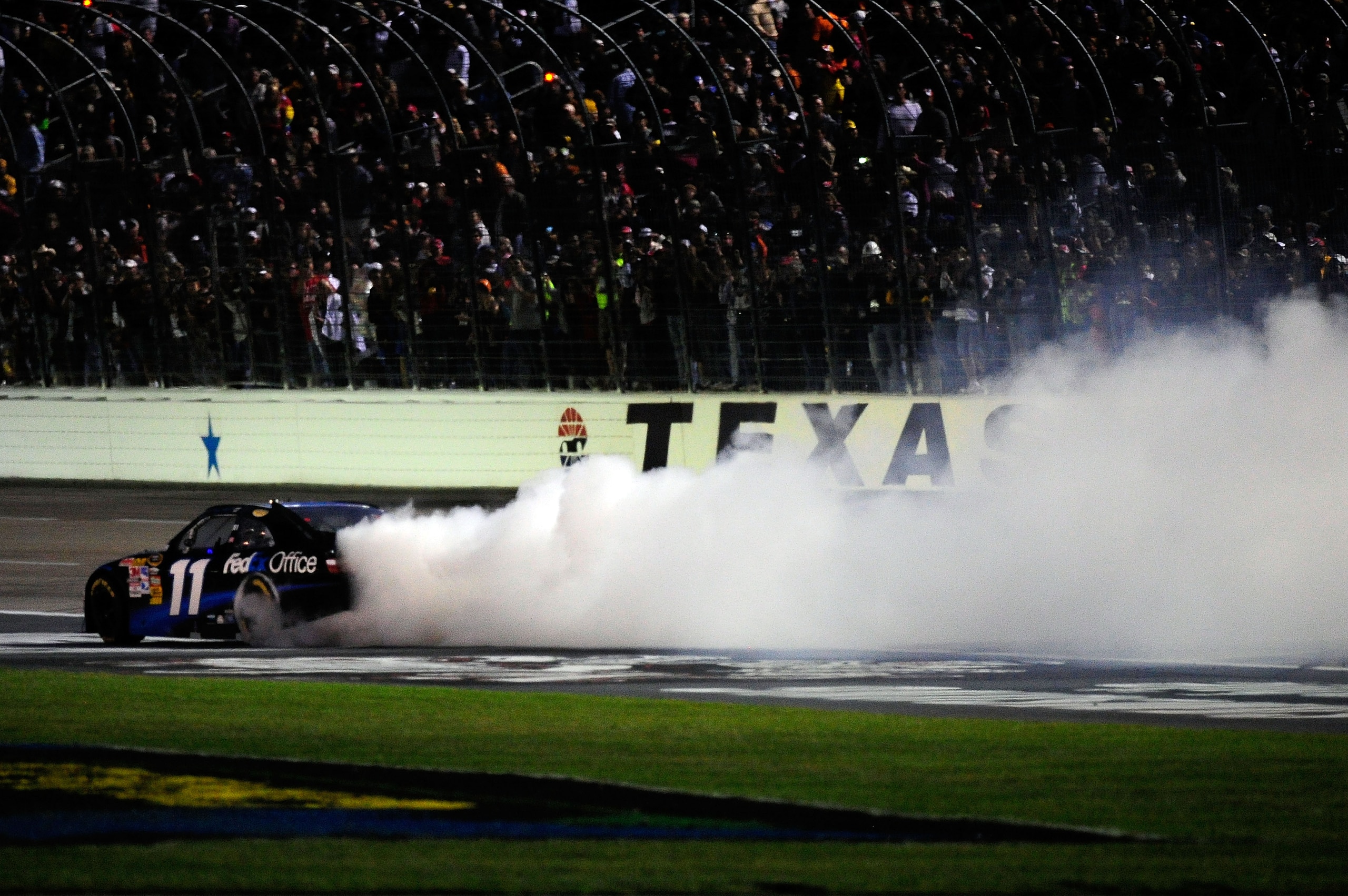 FORT WORTH, TX - NOVEMBER 07: Denny Hamlin, driver of the #11 FedEx Office Toyota, celebrates with a burn out after winning the NASCAR Sprint Cup Series AAA Texas 500 at Texas Motor Speedway on November 7, 2010 in Fort Worth, Texas. (Photo by Robert Lab FORT WORTH, TX - NOVEMBER 07: Denny Hamlin, driver of the #11 FedEx Office Toyota, celebrates with a burn out after winning the NASCAR Sprint Cup Series AAA Texas 500 at Texas Motor Speedway on November 7, 2010 in Fort Worth, Texas. (Photo by Robert Lab