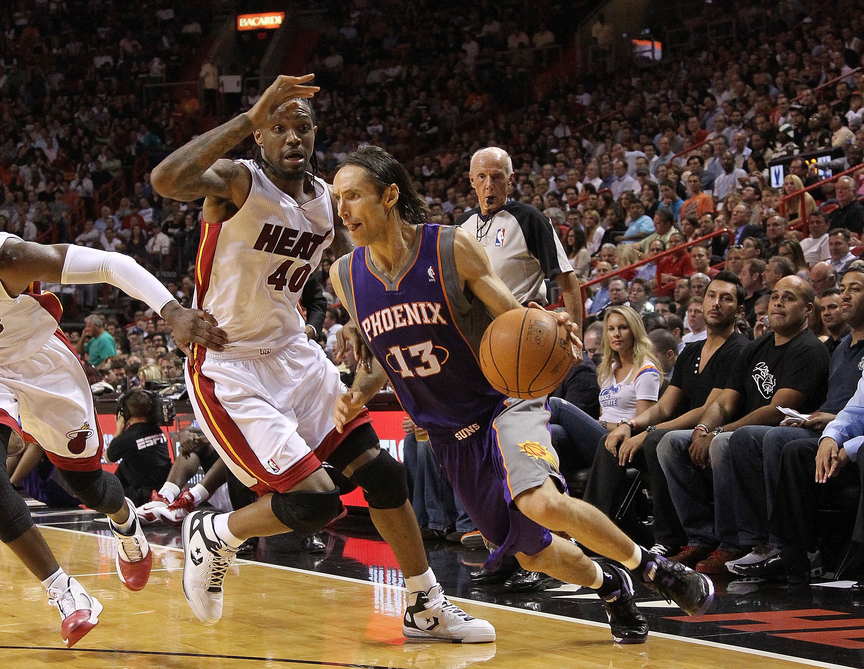 MIAMI - NOVEMBER 17:  Steve Nash #13  of the Phoenix Suns dribbles around Udonis Haslem #40 during a game against the  Miami Heat at American Airlines Arena on November 17, 2010 in Miami, Florida. NOTE TO USER: User expressly acknowledges and agrees that,