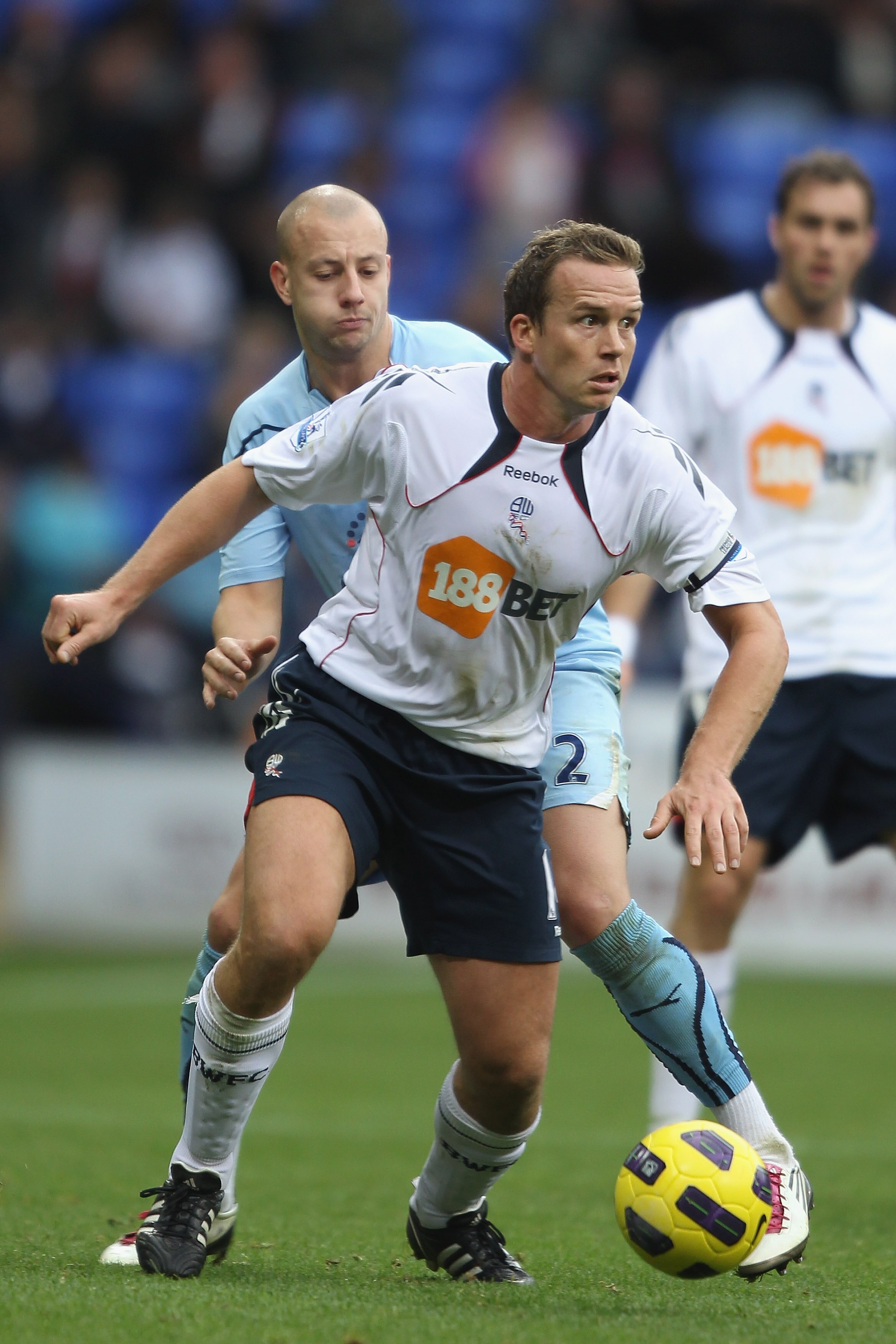BOLTON, ENGLAND - NOVEMBER 06:  Kevin Davies of Bolton Wanderers holds off a challenge from Alan Hutton of Tottenham Hotspur during the Barclays Premier League match between Bolton Wanderers and Tottenham Hotspur at the Reebok Stadium on November 6, 2010