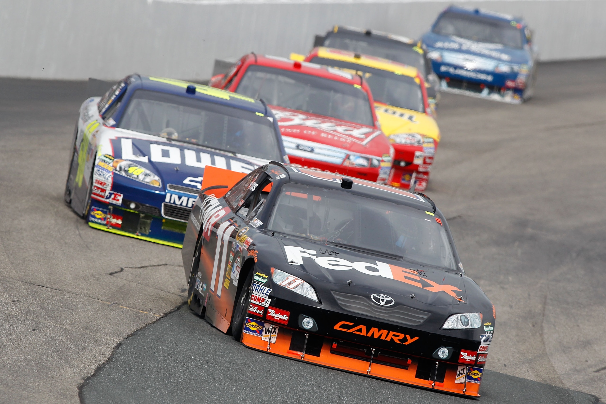 LOUDON, NH - SEPTEMBER 19: Denny Hamlin, driver of the #11 FedEx Small Business Toyota, and Jimmie Johnson, driver of the #48 Lowe's/John Manville Chevrolet, lead a pack of cars during the NASCAR Sprint Cup Series Sylvania 300 at New Hampshire Motor Spee LOUDON, NH - SEPTEMBER 19: Denny Hamlin, driver of the #11 FedEx Small Business Toyota, and Jimmie Johnson, driver of the #48 Lowe's/John Manville Chevrolet, lead a pack of cars during the NASCAR Sprint Cup Series Sylvania 300 at New Hampshire Motor Spee