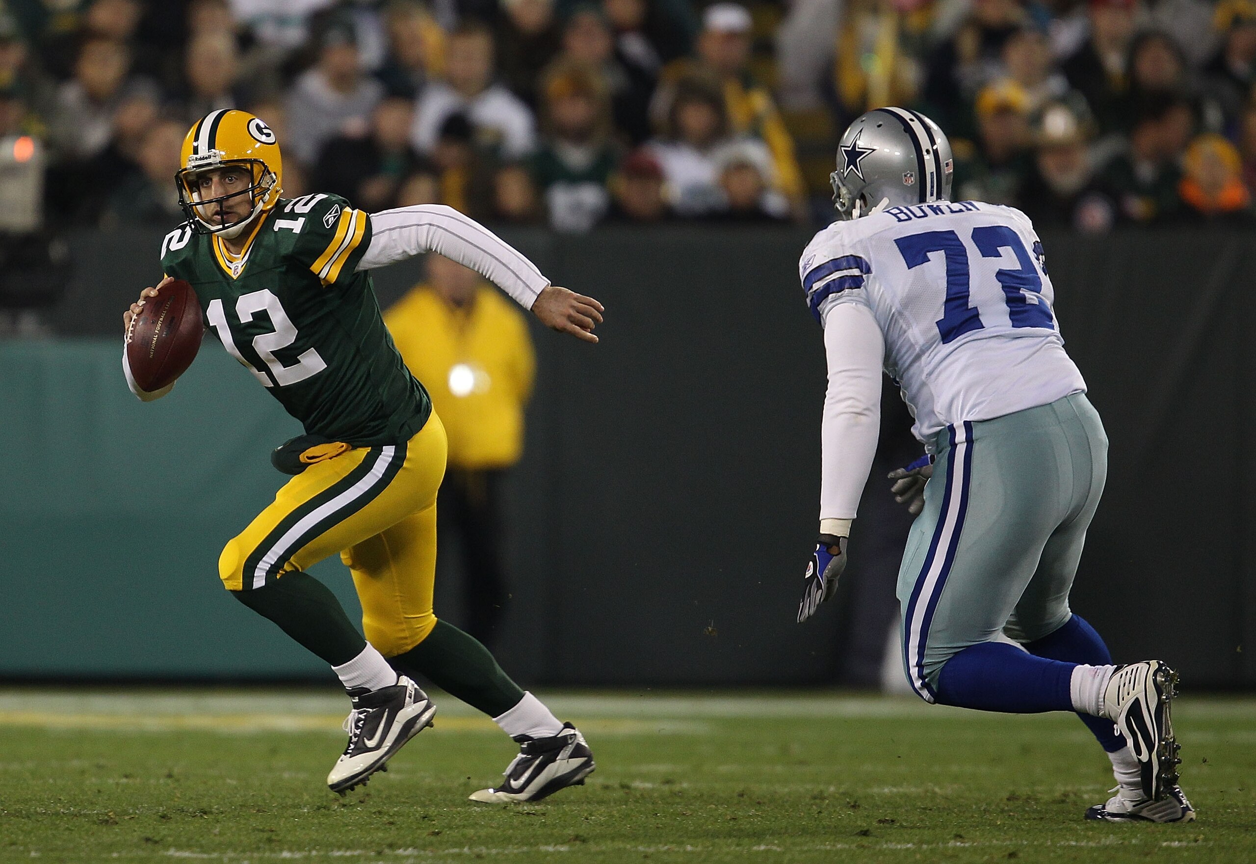 GREEN BAY, WI - NOVEMBER 07: Aaron Rodgers #12 of the Green Bay Packers runs out of the pocket while looking for a receiver pursued by Stephen Bowen #72 of the Dallas Cowboys at Lambeau Field on November 7, 2010 in Green Bay, Wisconsin. The Packers defeat GREEN BAY, WI - NOVEMBER 07: Aaron Rodgers #12 of the Green Bay Packers runs out of the pocket while looking for a receiver pursued by Stephen Bowen #72 of the Dallas Cowboys at Lambeau Field on November 7, 2010 in Green Bay, Wisconsin. The Packers defeat