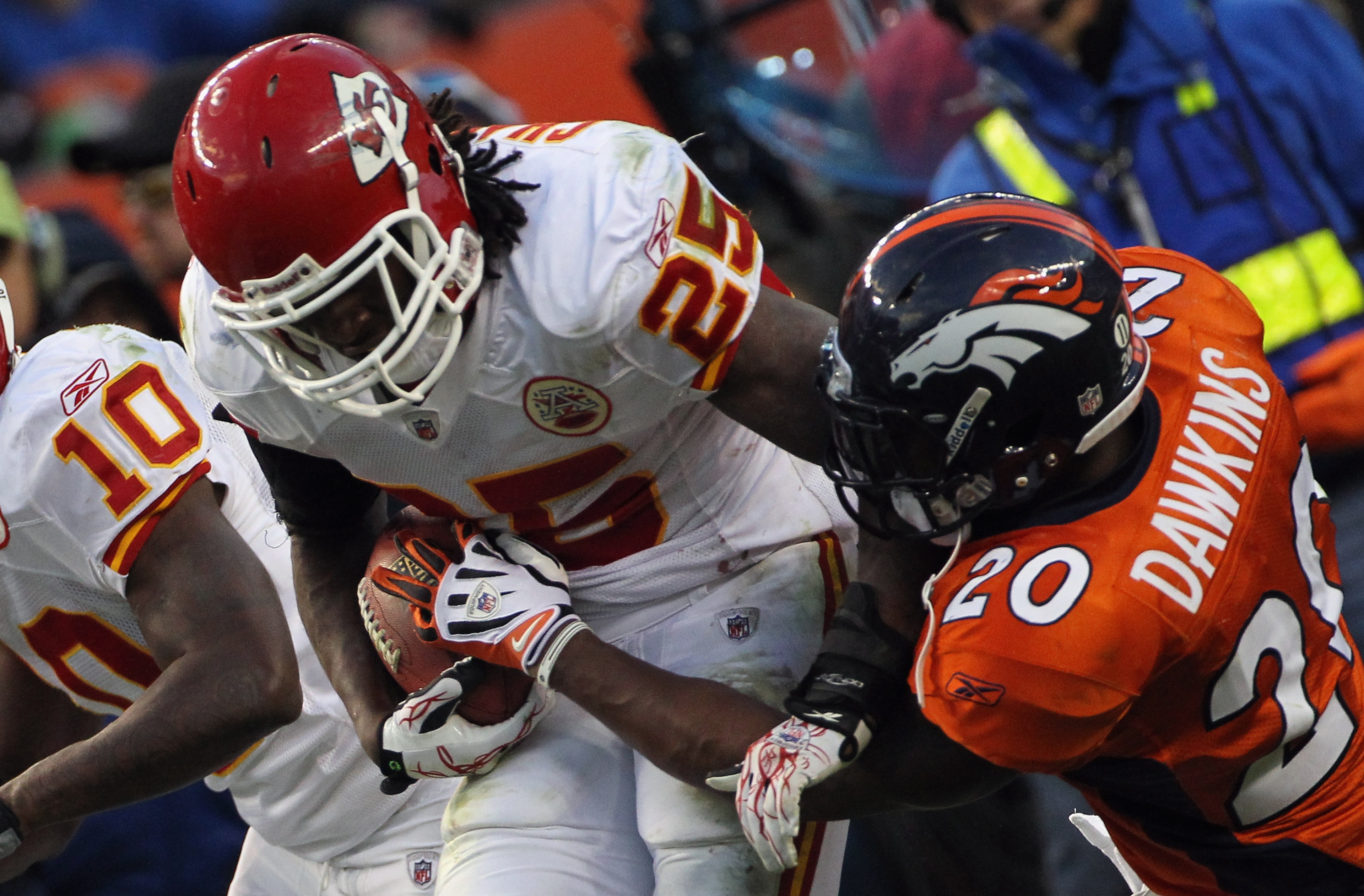 DENVER - NOVEMBER 14:  Running back Jamaal Charles #25 of the Kansas City Chiefs rushes as Brian Dawkins #20 of the Denver Broncos tries to strip the ball at INVESCO Field at Mile High on November 14, 2010 in Denver, Colorado. The Broncos defeated the Chi