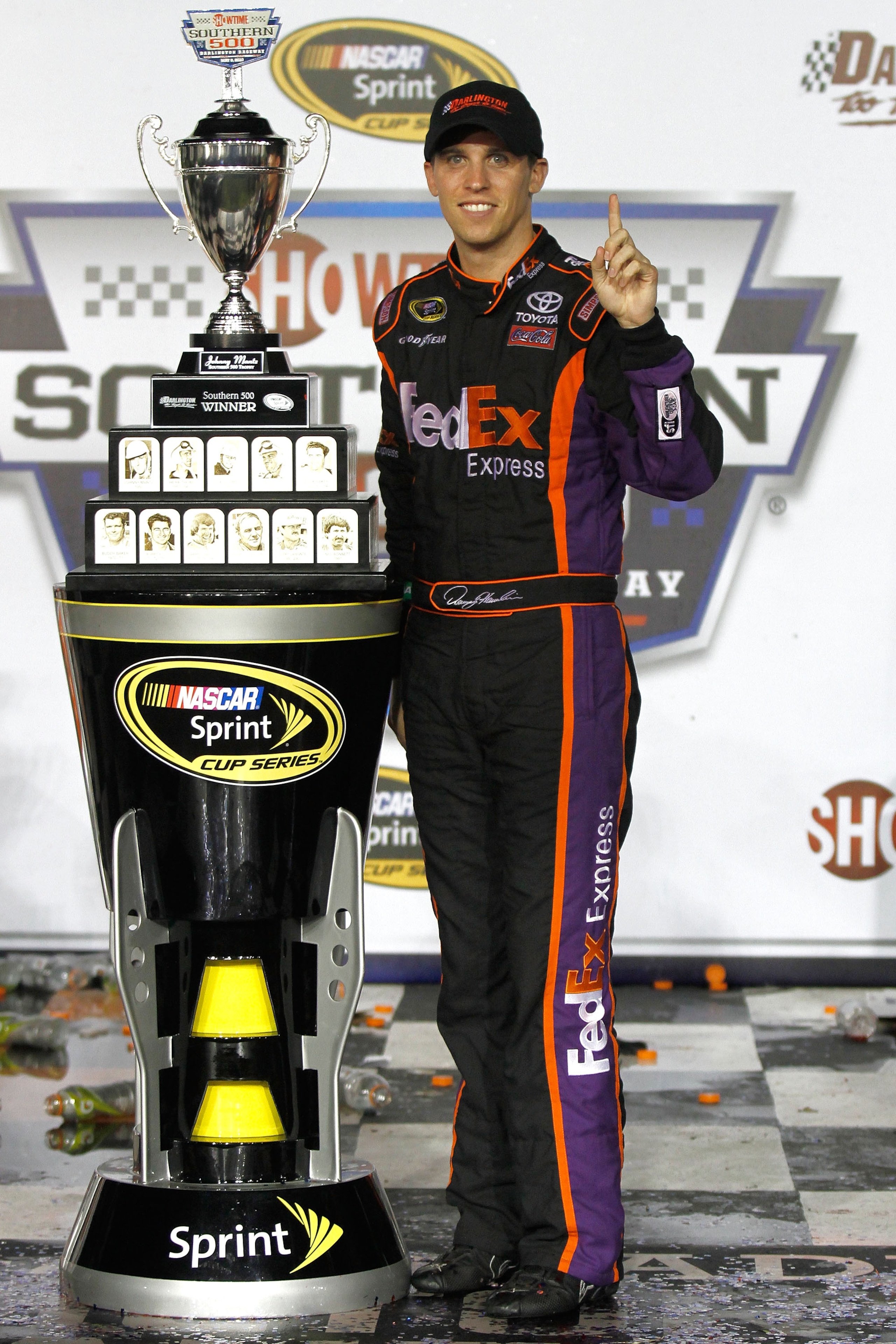 DARLINGTON, SC - MAY 08: Denny Hamlin, driver of the #11 FedEx Express Toyota, celebrates with the trophy in victory lane in celebration of winning the NASCAR Sprint Cup series SHOWTIME Southern 500 at Darlington Raceway on May 8, 2010 in Darlington, Sou DARLINGTON, SC - MAY 08: Denny Hamlin, driver of the #11 FedEx Express Toyota, celebrates with the trophy in victory lane in celebration of winning the NASCAR Sprint Cup series SHOWTIME Southern 500 at Darlington Raceway on May 8, 2010 in Darlington, Sou