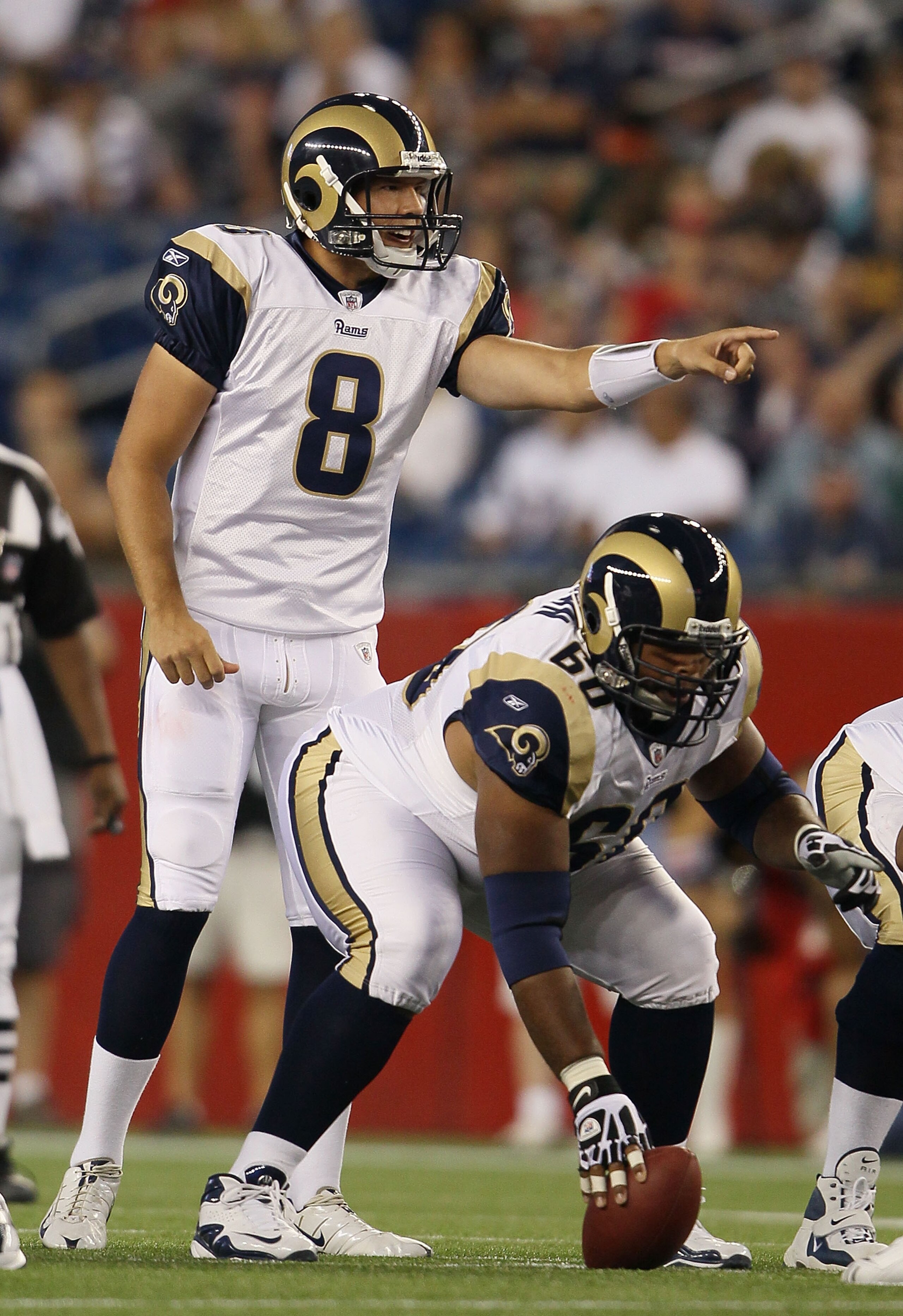 FOXBORO, MA - AUGUST 26:  Sam Bradford #8 of the St. Louis Rams calls out the play as Jason Brown #60 holds the ball in the first half against the New England Patriots on August 26, 2010 at Gillette Stadium in Foxboro, Massachusetts.  (Photo by Elsa/Getty
