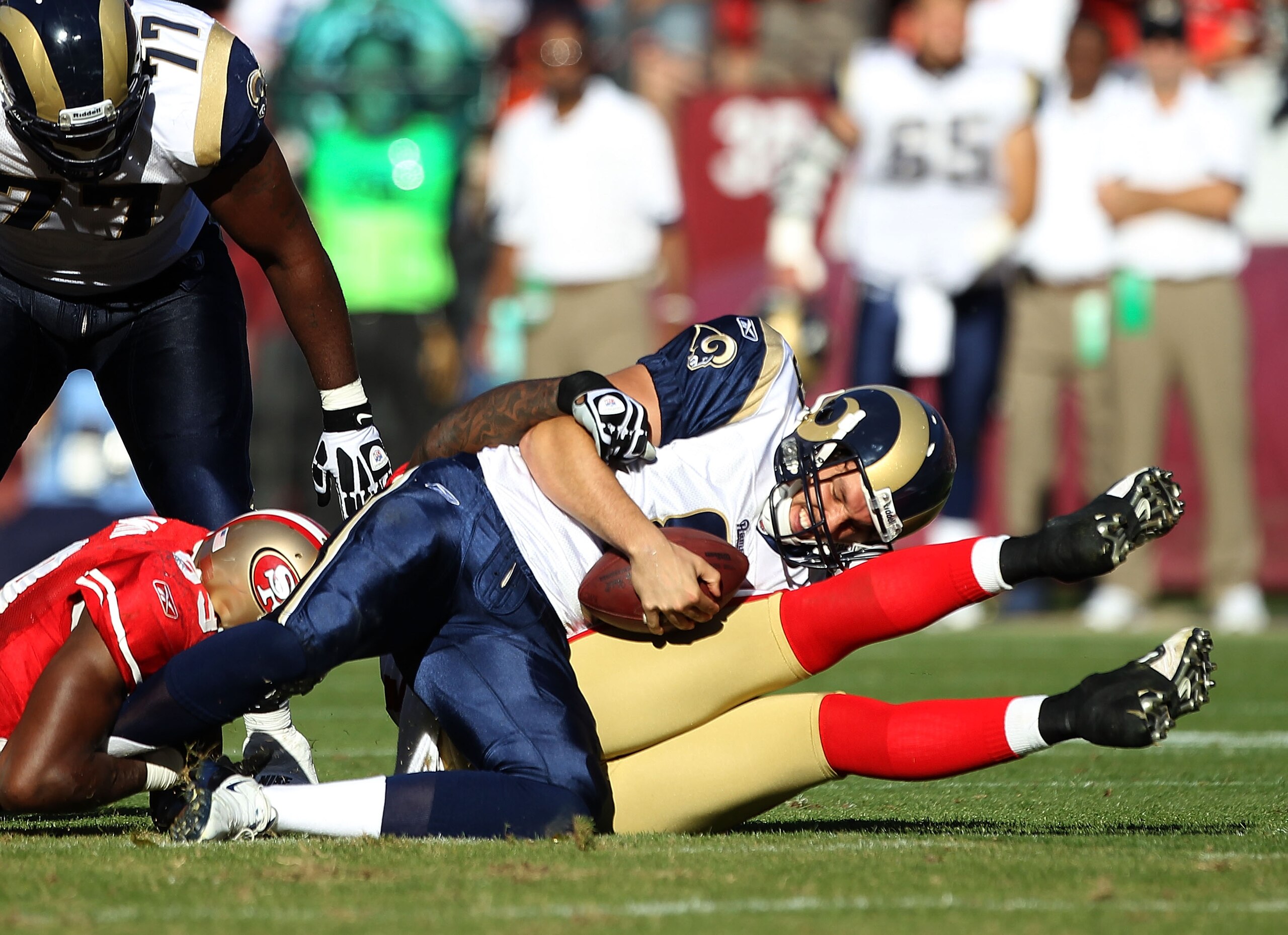 SAN FRANCISCO - NOVEMBER 14:  Sam Bradford #8 of the St. Louis Rams is sacked by the San Francisco 49ers at Candlestick Park on November 14, 2010 in San Francisco, California.  (Photo by Ezra Shaw/Getty Images)