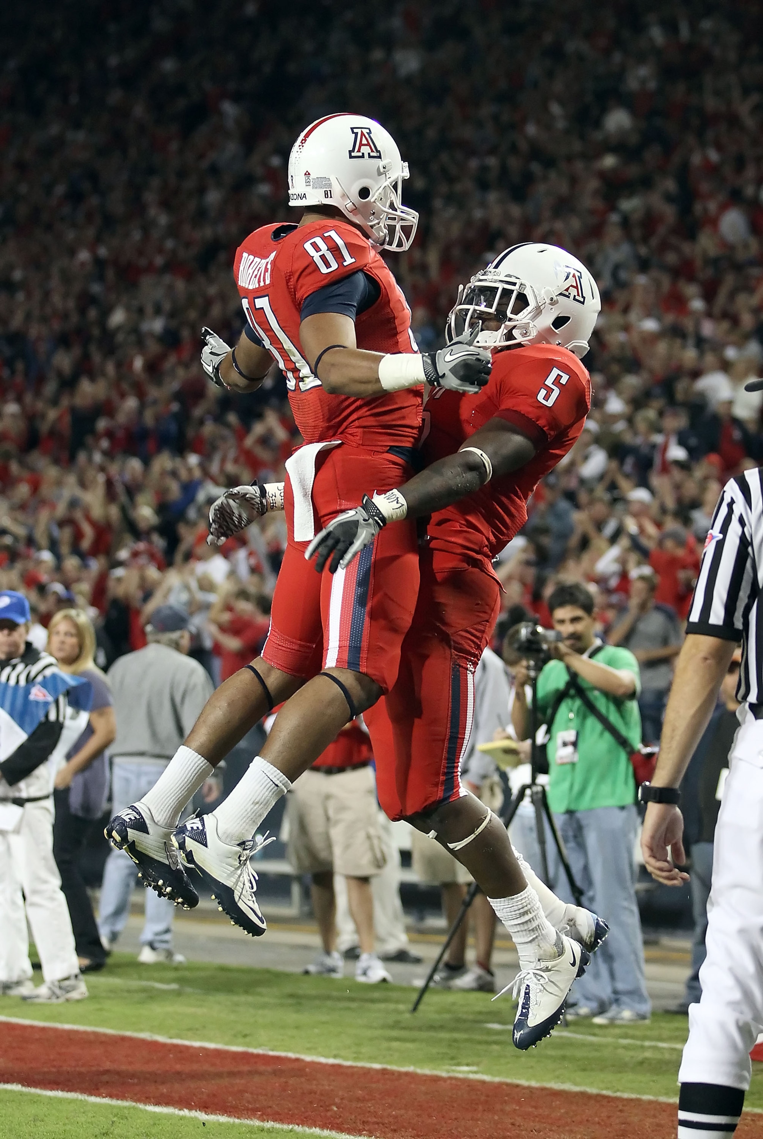 TUCSON, AZ - OCTOBER 23:  Runningback Nic Grigsby #5 of the Arizona Wildcats celebrates with David Roberts #81 after scoring a 4 yard rushing touchdown agianst the Washington Huskies during the third quarter of the college football game at Arizona Stadium