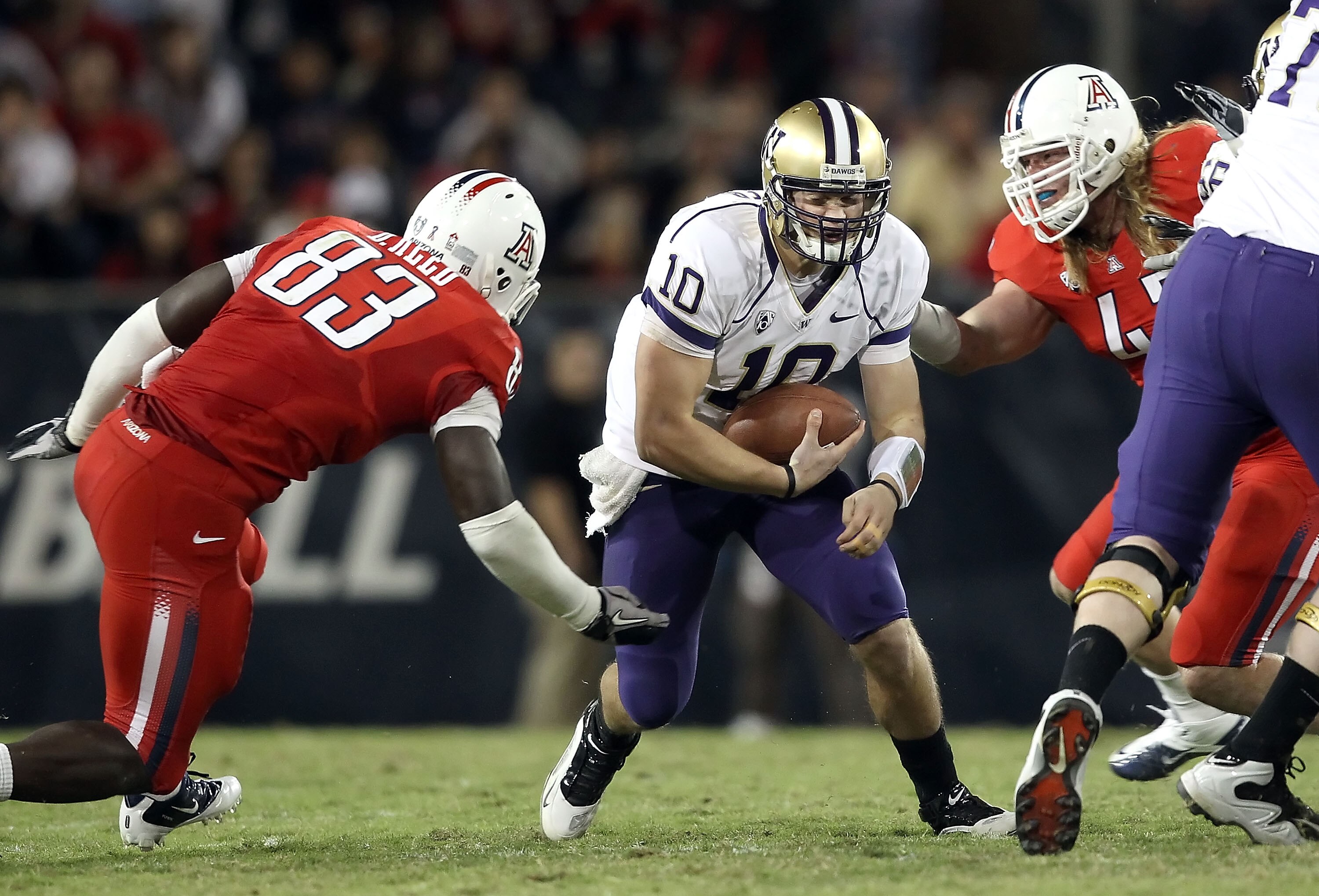 TUCSON, AZ - OCTOBER 23:  Quarterback Jake Locker #10 of the Washington Huskies runs with the football during the college football game against the Arizona Wildcats at Arizona Stadium on October 23, 2010 in Tucson, Arizona. The Wildcats defeated the Huski
