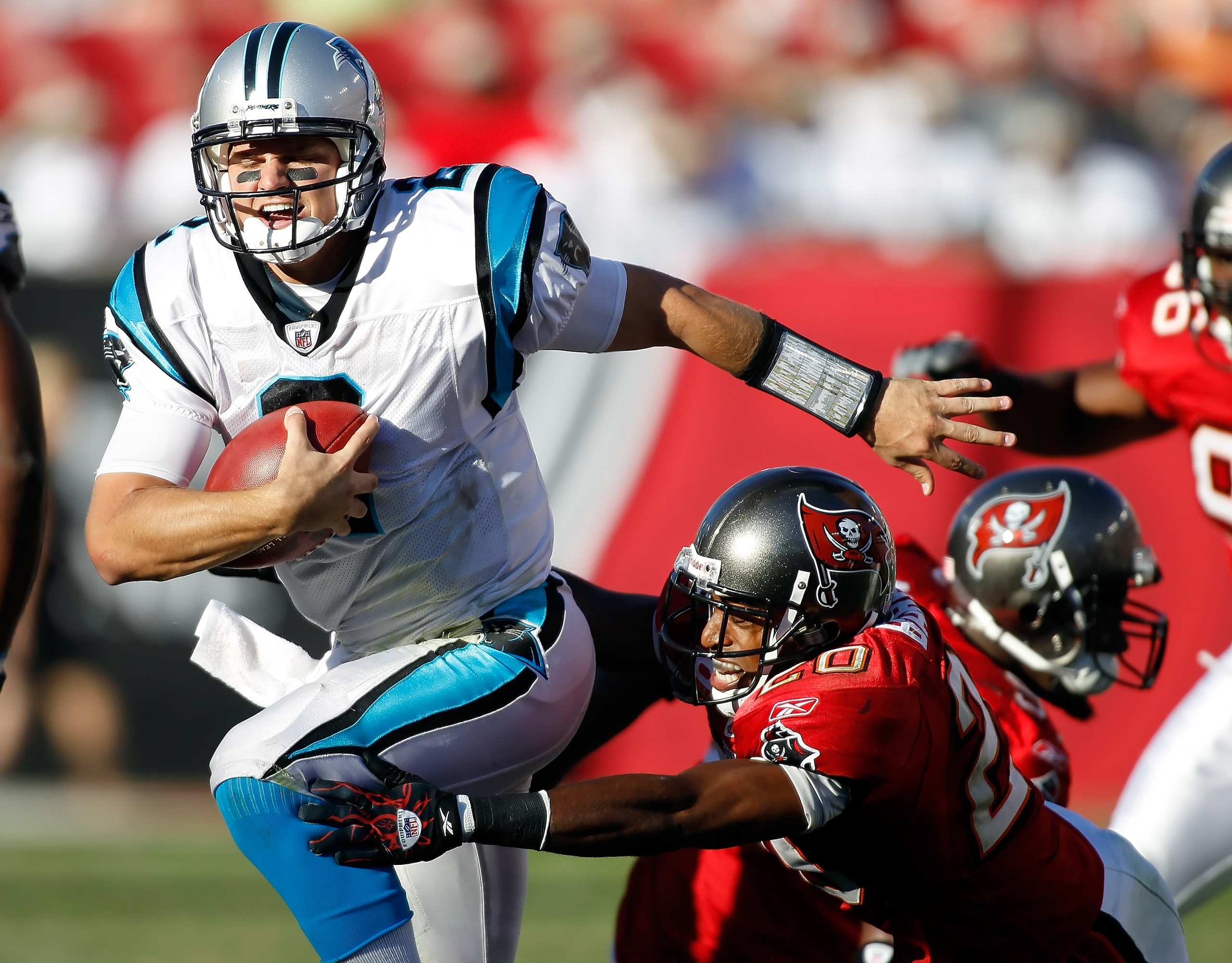 TAMPA, FL - NOVEMBER 14:  Defensive back Ronde Barber #20 of the Tampa Bay Buccaneers tackles quarterback Jimmy Clausen #2 of the Carolina Panthers during the game at Raymond James Stadium on November 14, 2010 in Tampa, Florida.  (Photo by J. Meric/Getty 