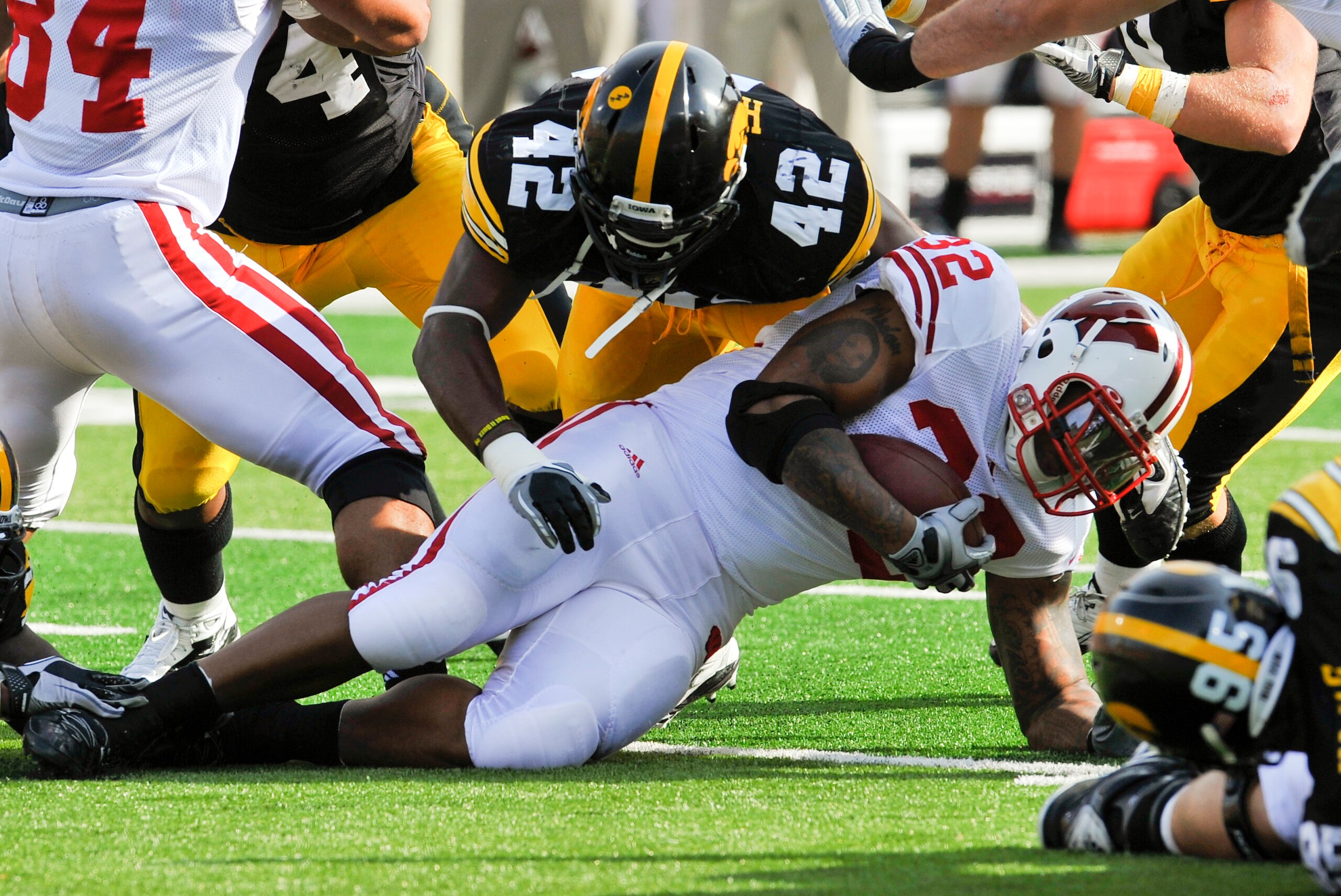 IOWA CITY, IA - OCTOBER 23- Line backer Jeremiaha Hunter #42 of the University of Iowa Hawkeyes tackles running back John Clay #32 of the Wisconsin Badgers during the first half of play at Kinnick Stadium on October 23, 2010 in Iowa City, Iowa. Wisconsin