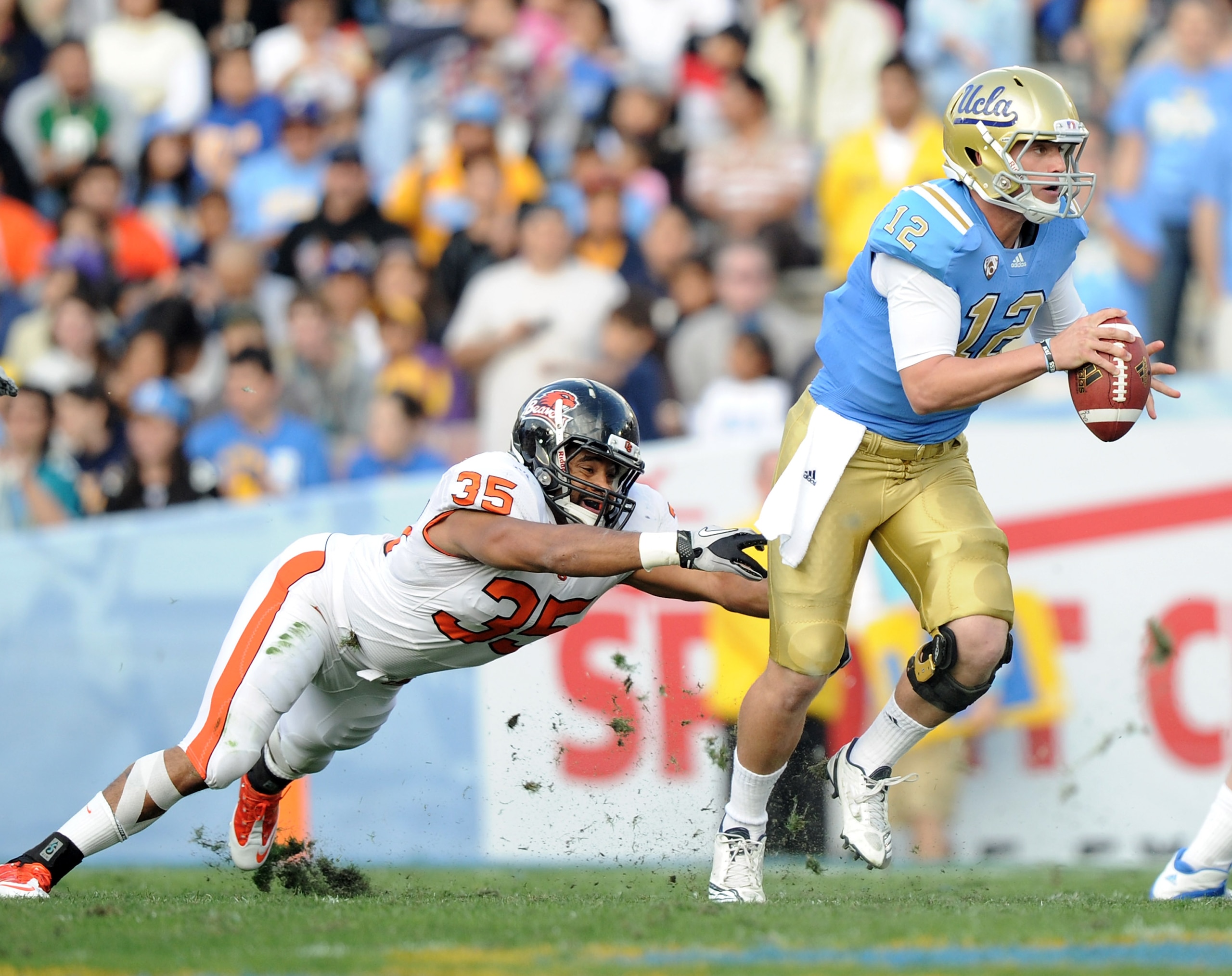 PASADENA, CA - NOVEMBER 06: Richard Brehaut #12 of the UCLA Bruins scrambles away from Keith Pankey #35 of the Oregon State Beavers at the Rose Bowl on November 6, 2010 in Pasadena, California. (Photo by Harry How/Getty Images) PASADENA, CA - NOVEMBER 06: Richard Brehaut #12 of the UCLA Bruins scrambles away from Keith Pankey #35 of the Oregon State Beavers at the Rose Bowl on November 6, 2010 in Pasadena, California. (Photo by Harry How/Getty Images)
