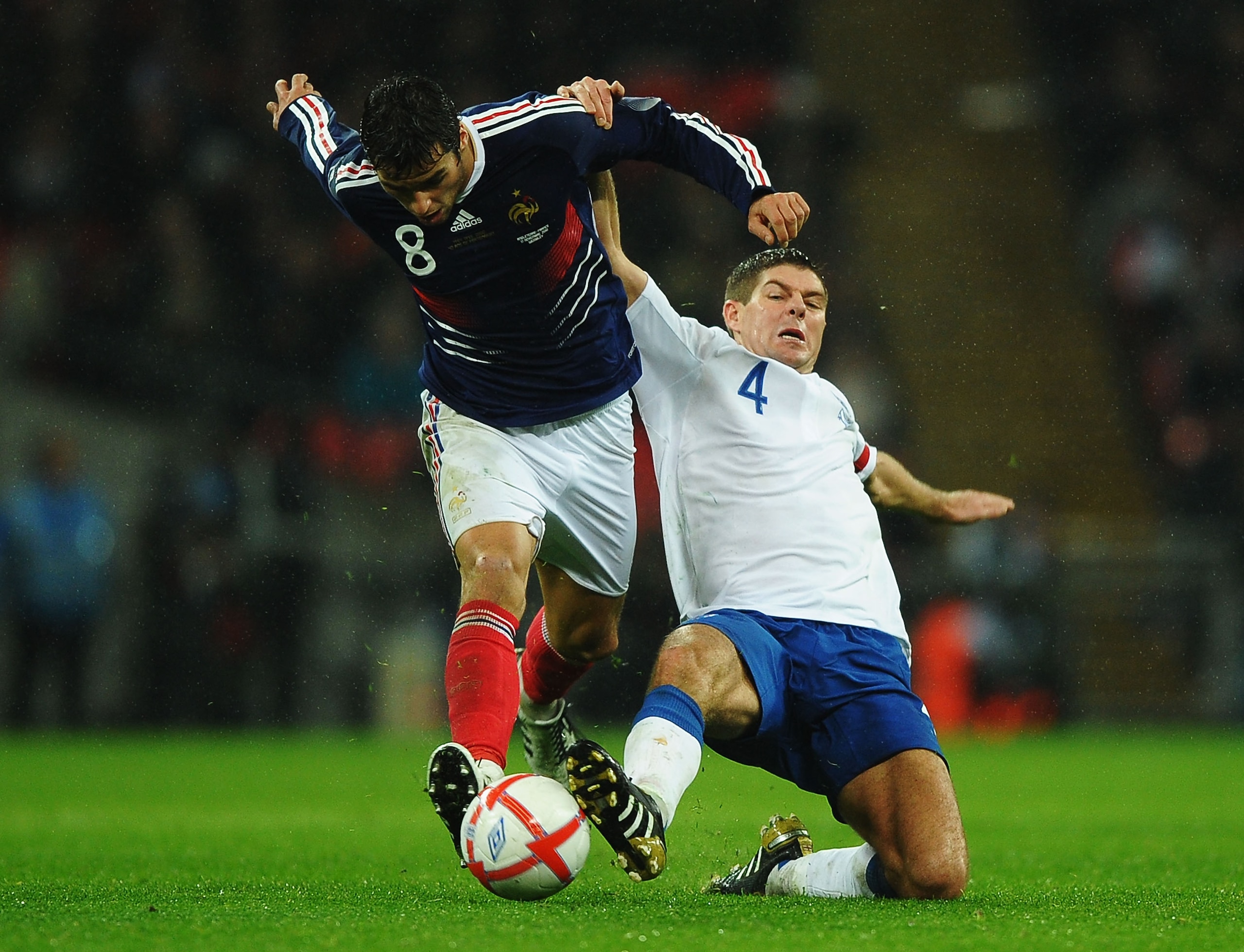 LONDON, ENGLAND - NOVEMBER 17:  Steven Gerrard of England tackles Yoann Gourcuff of France during the international friendly match between England and France at Wembley Stadium on November 17, 2010 in London, England.  (Photo by Laurence Griffiths/Getty I