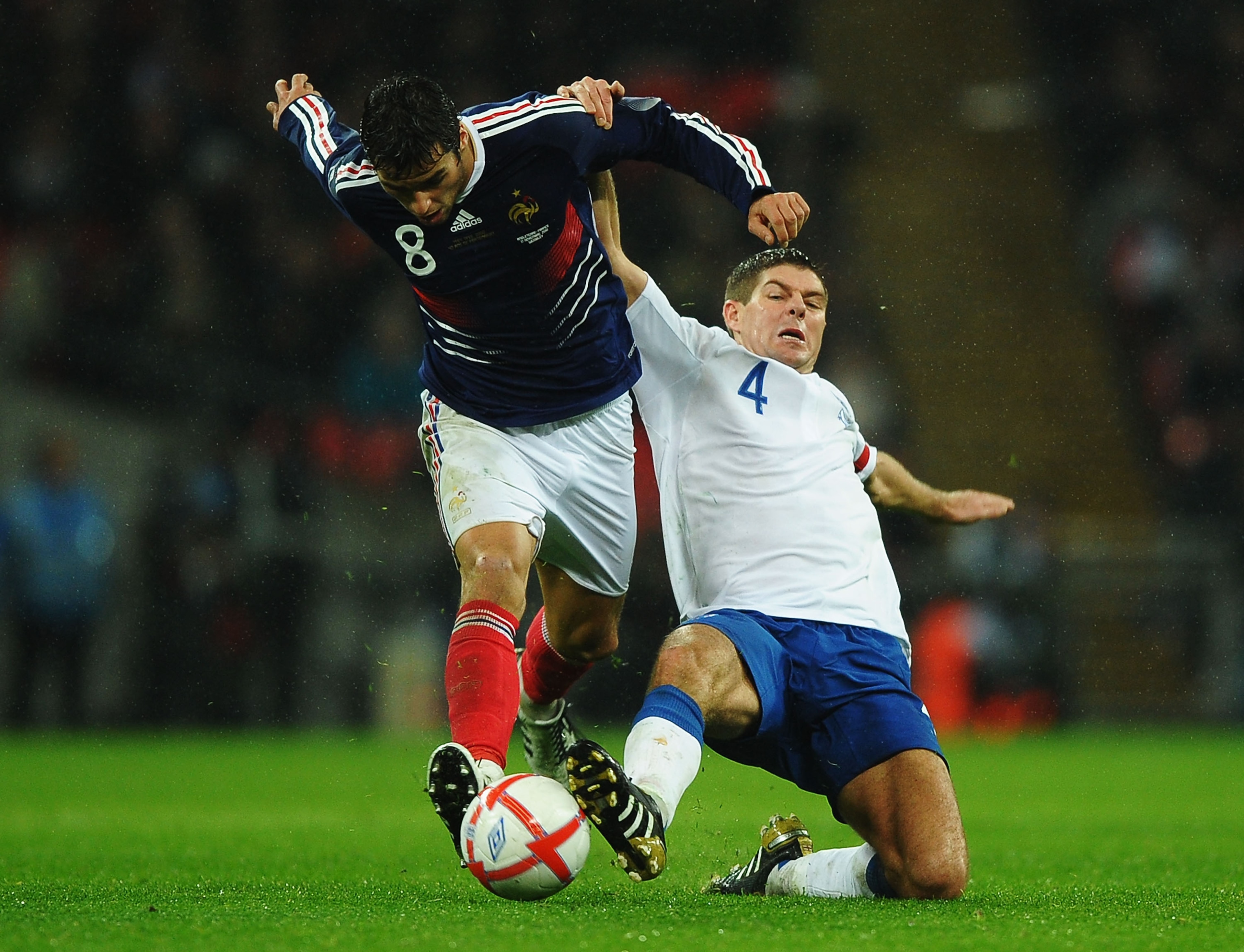 LONDON, ENGLAND - NOVEMBER 17: Steven Gerrard of England tackles Yoann Gourcuff of France during the international friendly match between England and France at Wembley Stadium on November 17, 2010 in London, England. (Photo by Laurence Griffiths/Getty I LONDON, ENGLAND - NOVEMBER 17: Steven Gerrard of England tackles Yoann Gourcuff of France during the international friendly match between England and France at Wembley Stadium on November 17, 2010 in London, England. (Photo by Laurence Griffiths/Getty I